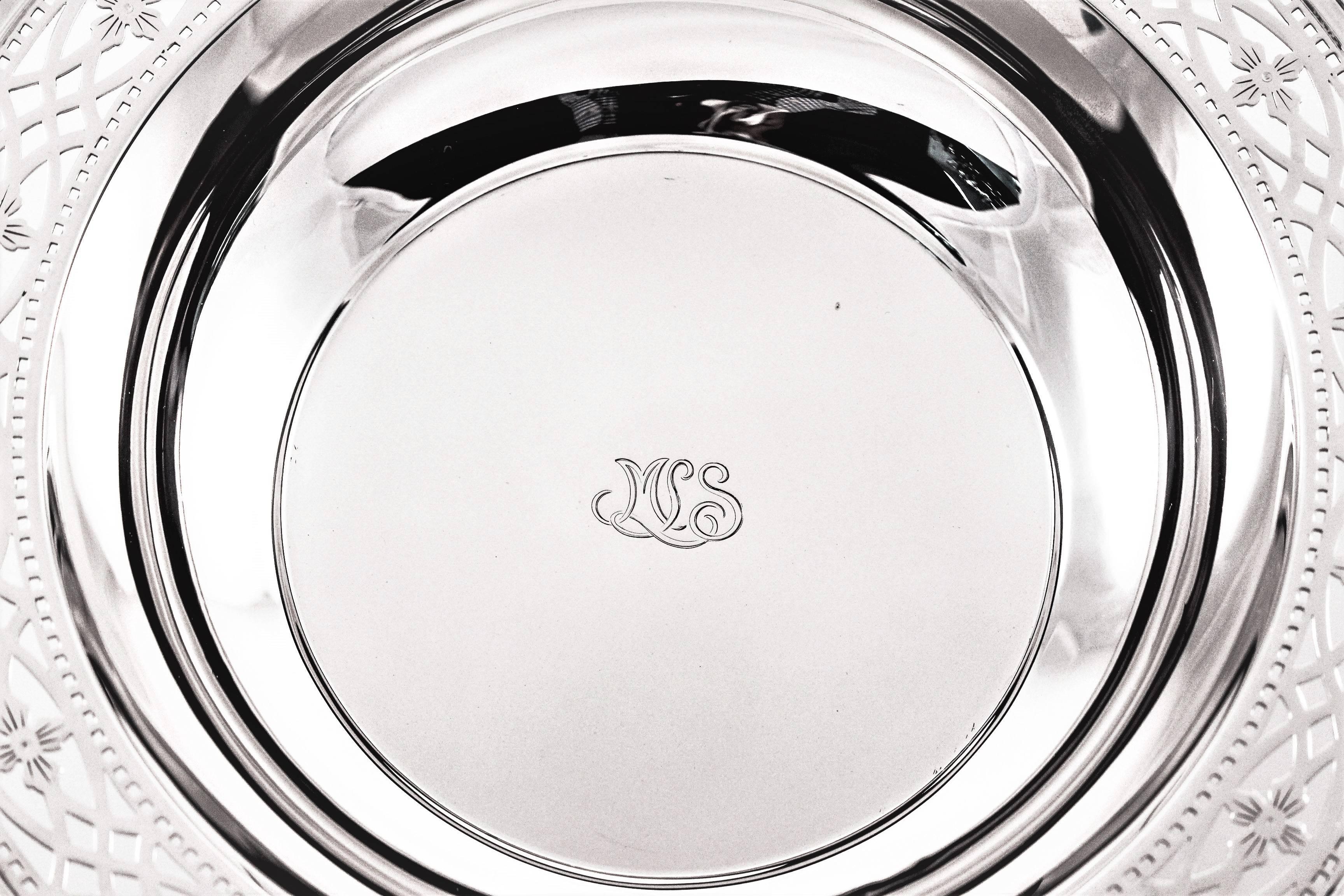 An inch wide border encircles the bowl. The border has a lovely lattice pattern of oval and diamond shaped cutouts. In the centre there is a hand engraved monogram in that distinctive Tiffany font.