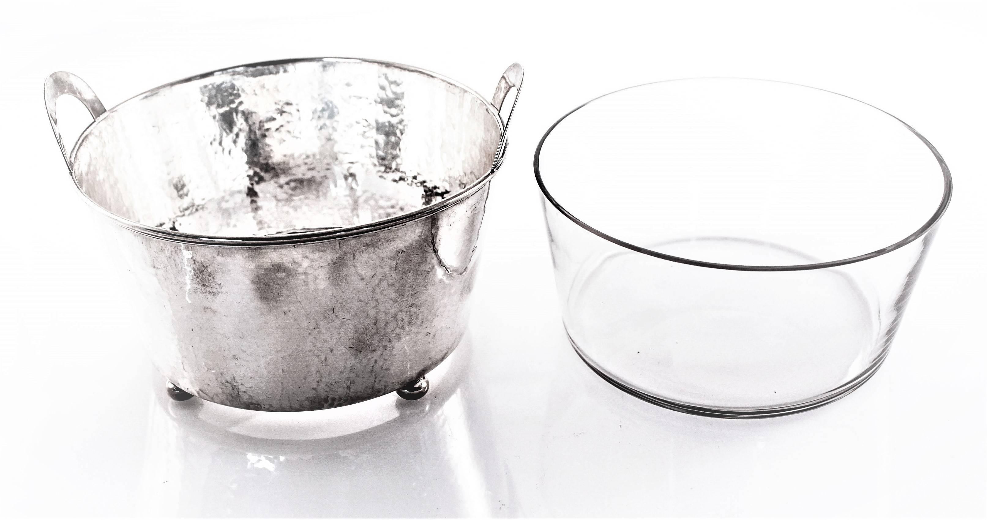 What a lovely way to serve ice on a dinner table. This hand-hammered ice bucket comes with the original glass liner. The glass is removable making it a pleasure to clean. This piece can also be used for anything else you normally wouldn’t put in
