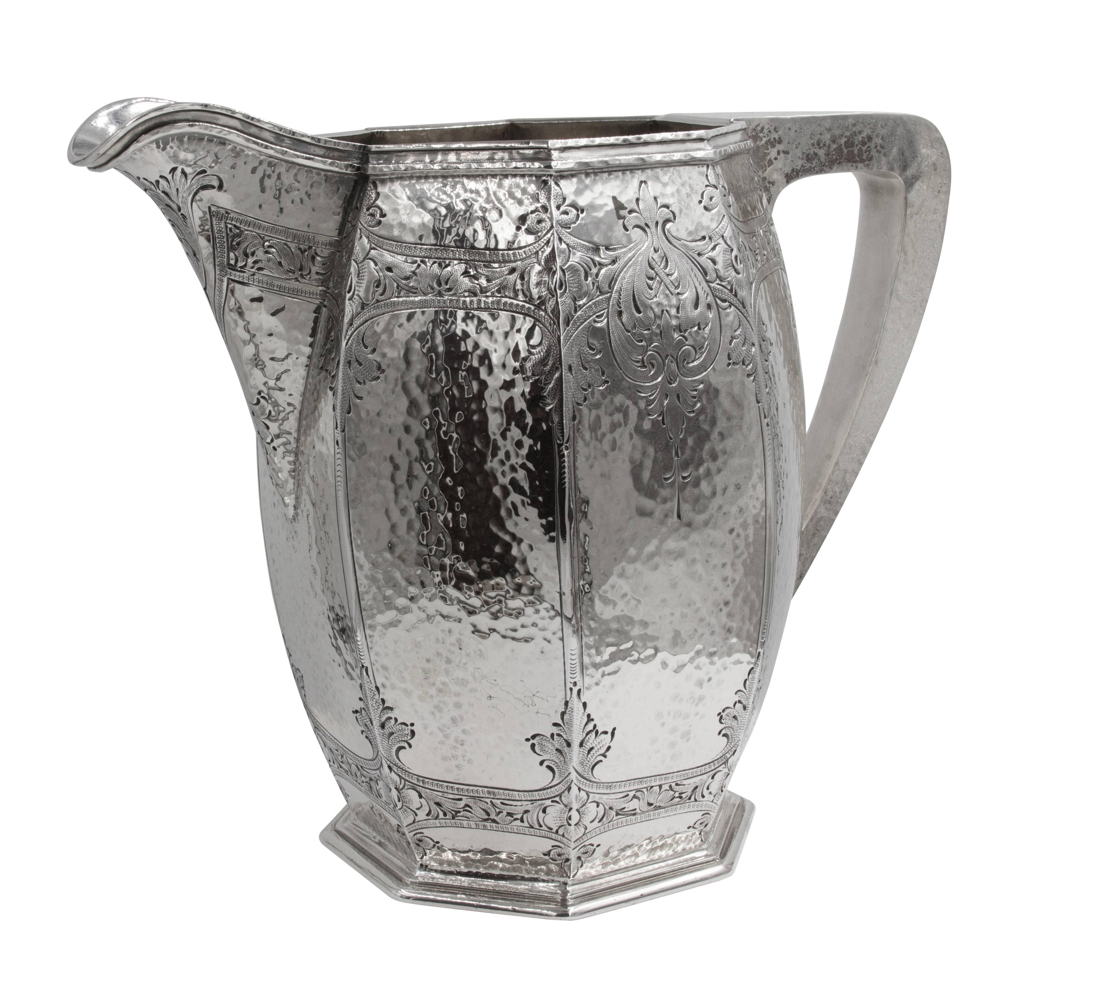 This hammered water pitcher is modern and yet has a traditional quality to it. Modern in shape and texture (hammered) this piece has pretty etching around both the top and bottom, giving it a softer delicate feel. Unlike most water pitchers that are