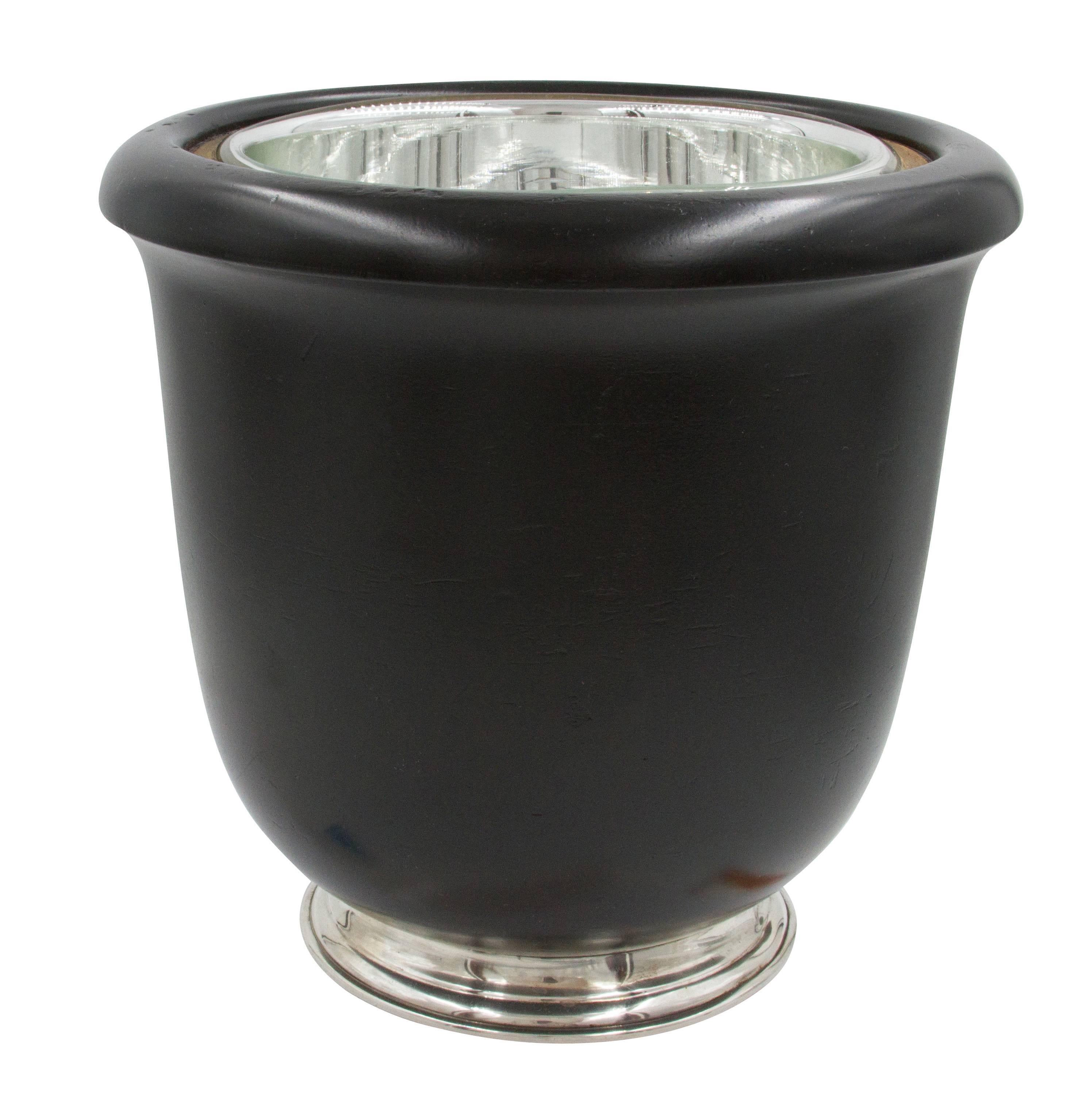 This Art Deco ice bucket has a sterling base and cover. The body is made of black wood. This unusual piece will definitely peak ever ones curiosity. If you like the rare and unusual this is your piece.