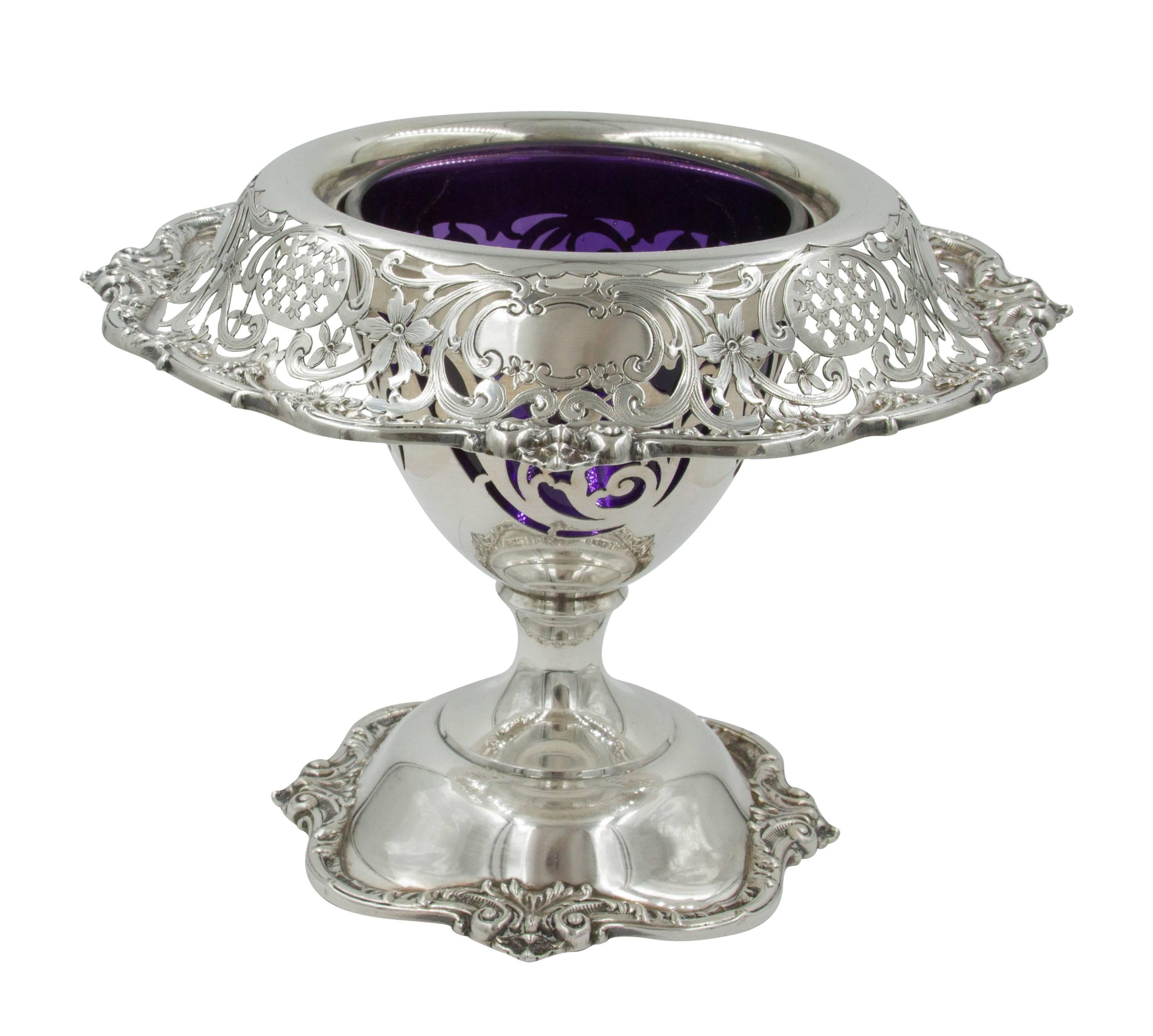 Here are a pair of floral urns with deep purple glass liners. They have scalloped bases as well as a wide rim that is scalloped too. The rim is 2