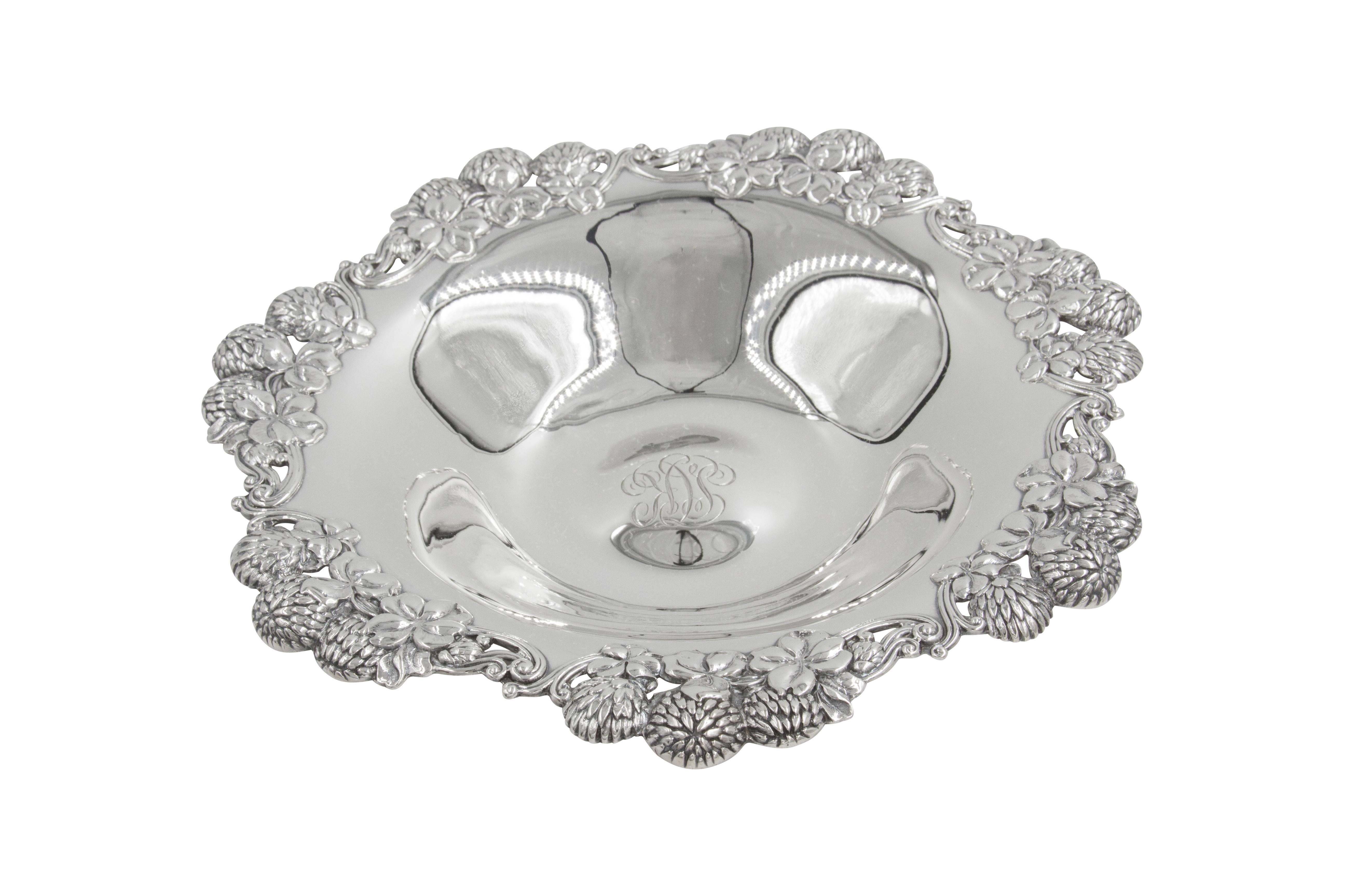 Here are a pair of lovely Tiffany & Co candy dishes that are the perfect size for a coffee table. Modern dishes with a rich ornate scalloped rim. Hydrangeas and other flowers in groups of three encircle the dishes, giving them an impressive look.