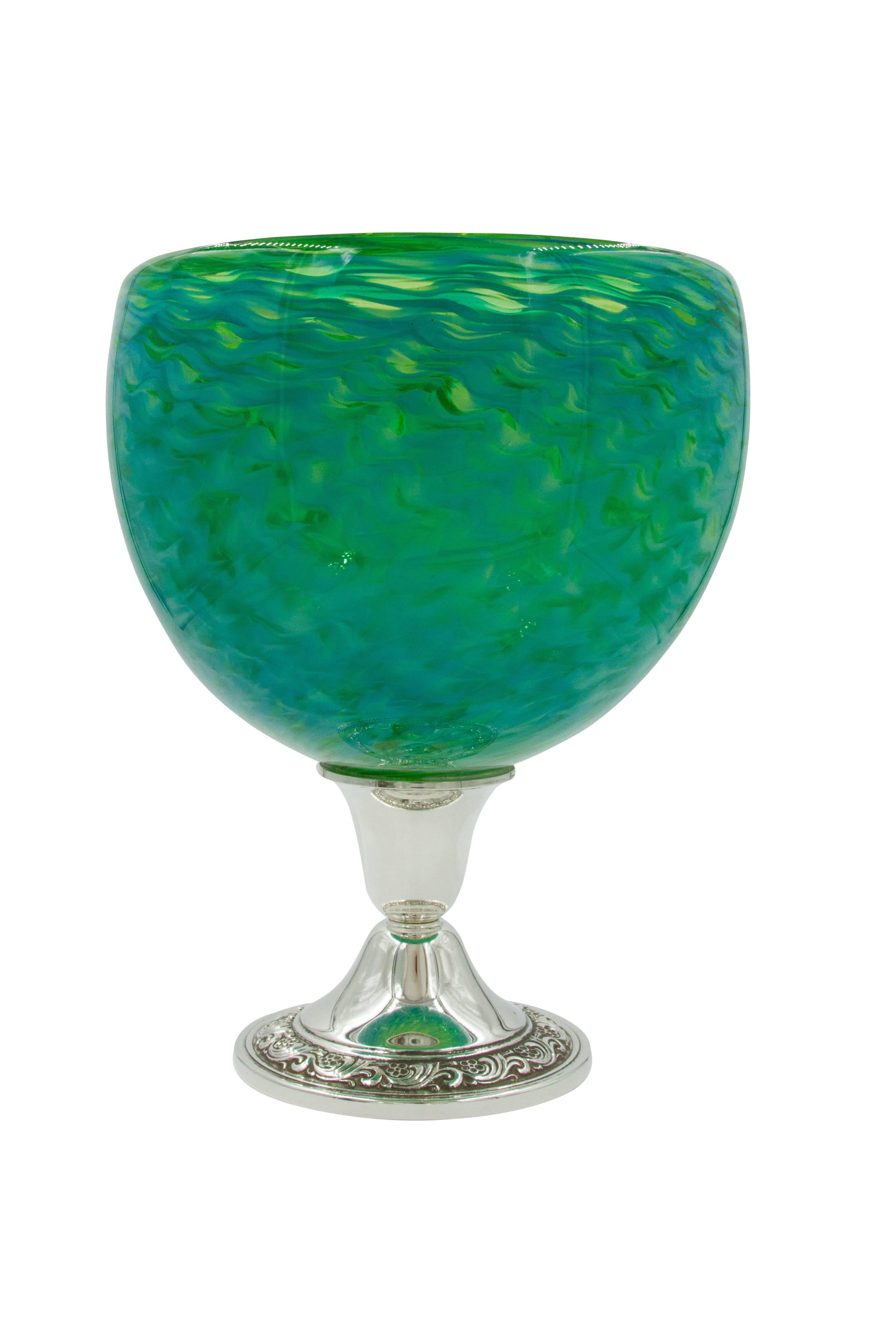Who said silver has to be serious and dressy? Here's proof that it can be fun and more casual. Introducing a pair of colored glass bowls with a sterling base. Blue, yellow and green come together in wave-like strokes. The rim of the base has that
