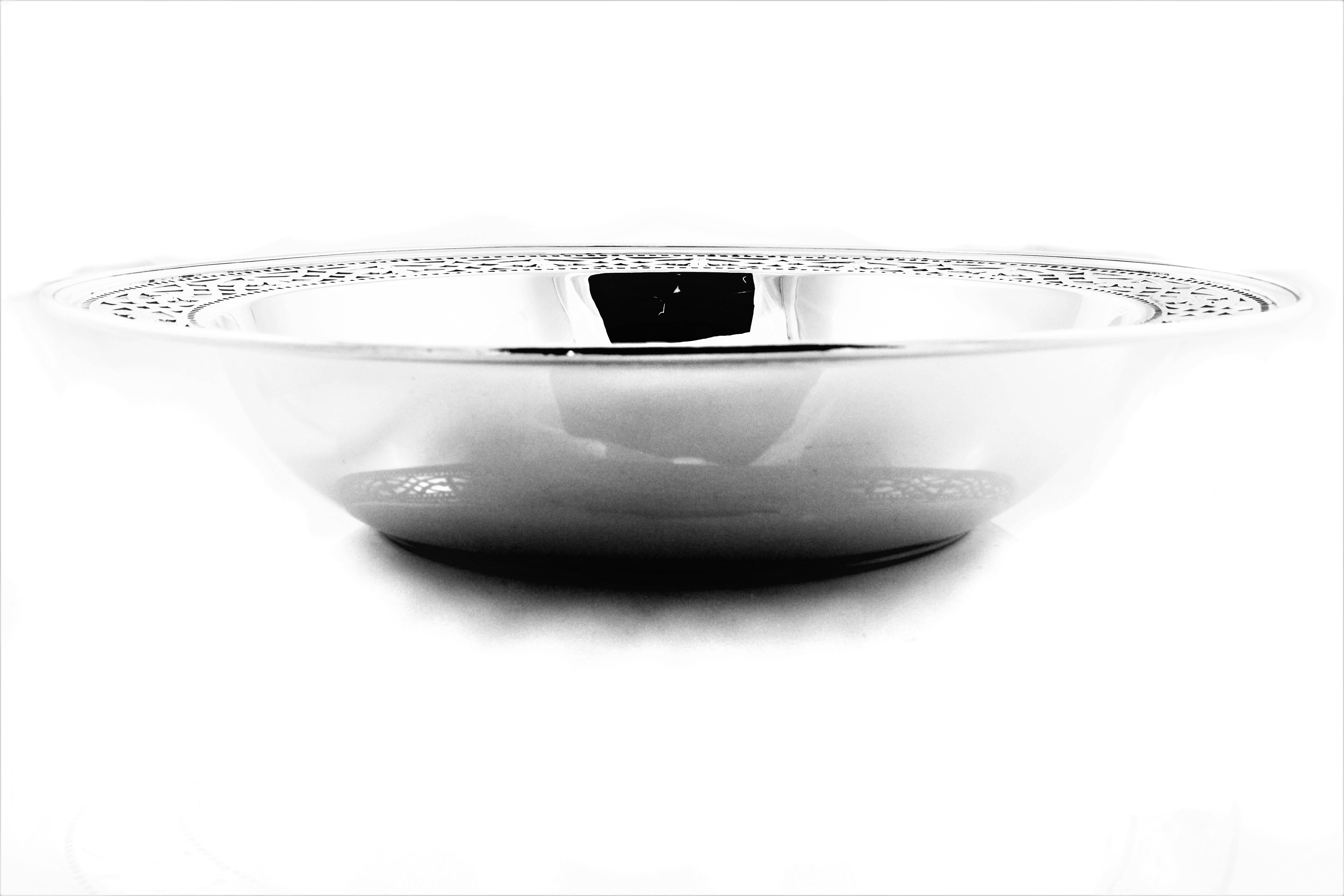 Being offered is a Tiffany & Co bowl with an inch of lattice work around the top. Acting of cut-out squares runs both above and under the larger lattice work. In the center a monogrammed 