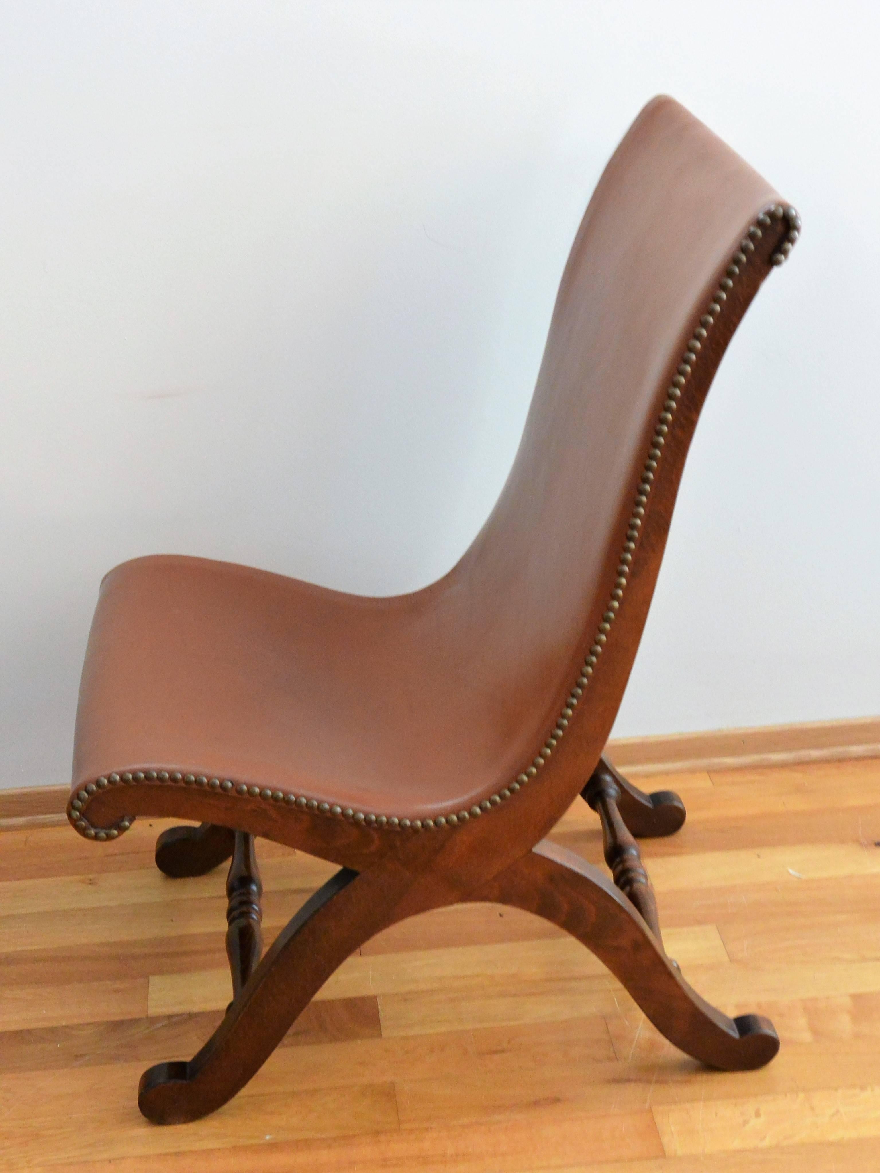 Fabulous Pierre Lottier leather slipper chairs originate from the 1940s-1950s. They were designed by Pierre Lottier for Valenti and were made in Spain. The thick leather hide on the chair pair remains near to the original condition and slight use.