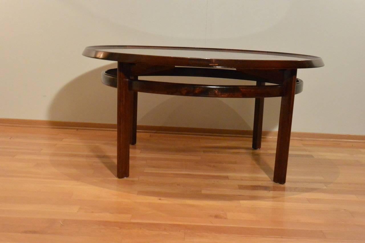 Solid rosewood round table called Bellis and designed by Torbjorn Afdal and manufactured by Bruksbo, Noway. Large, spacious, the red warm rosewood creates a warm and inviting focal point within the room. Can be used as a coffee table, large flower