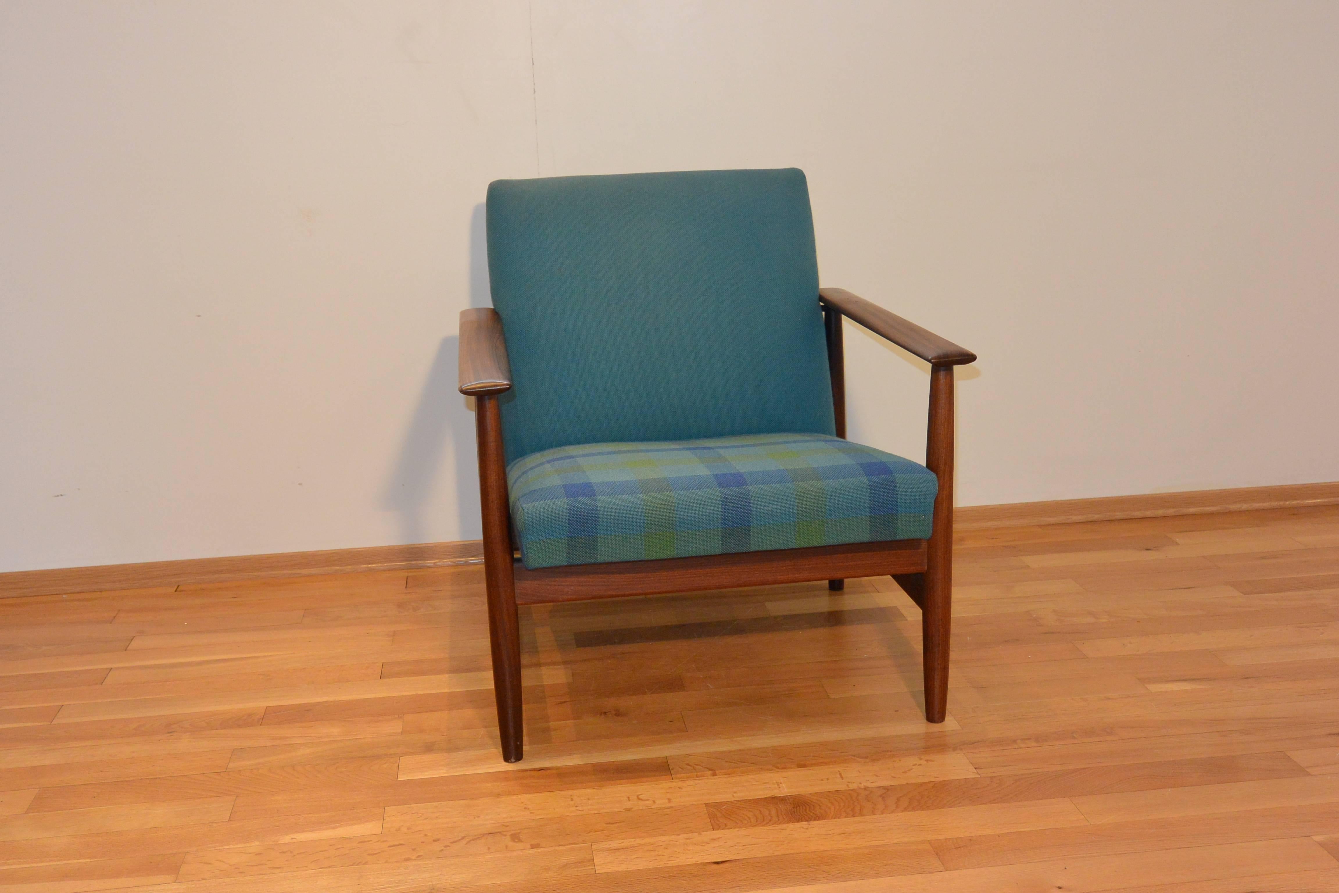 Blue Svane combina chair.

The Svane combina chair was designed by Ingmar Relling for Ekornes, Norway in the late 1960s. 
The fabric is in blue wool with a check pattern on the seat and with original upholstery. The frame is made from teak wood