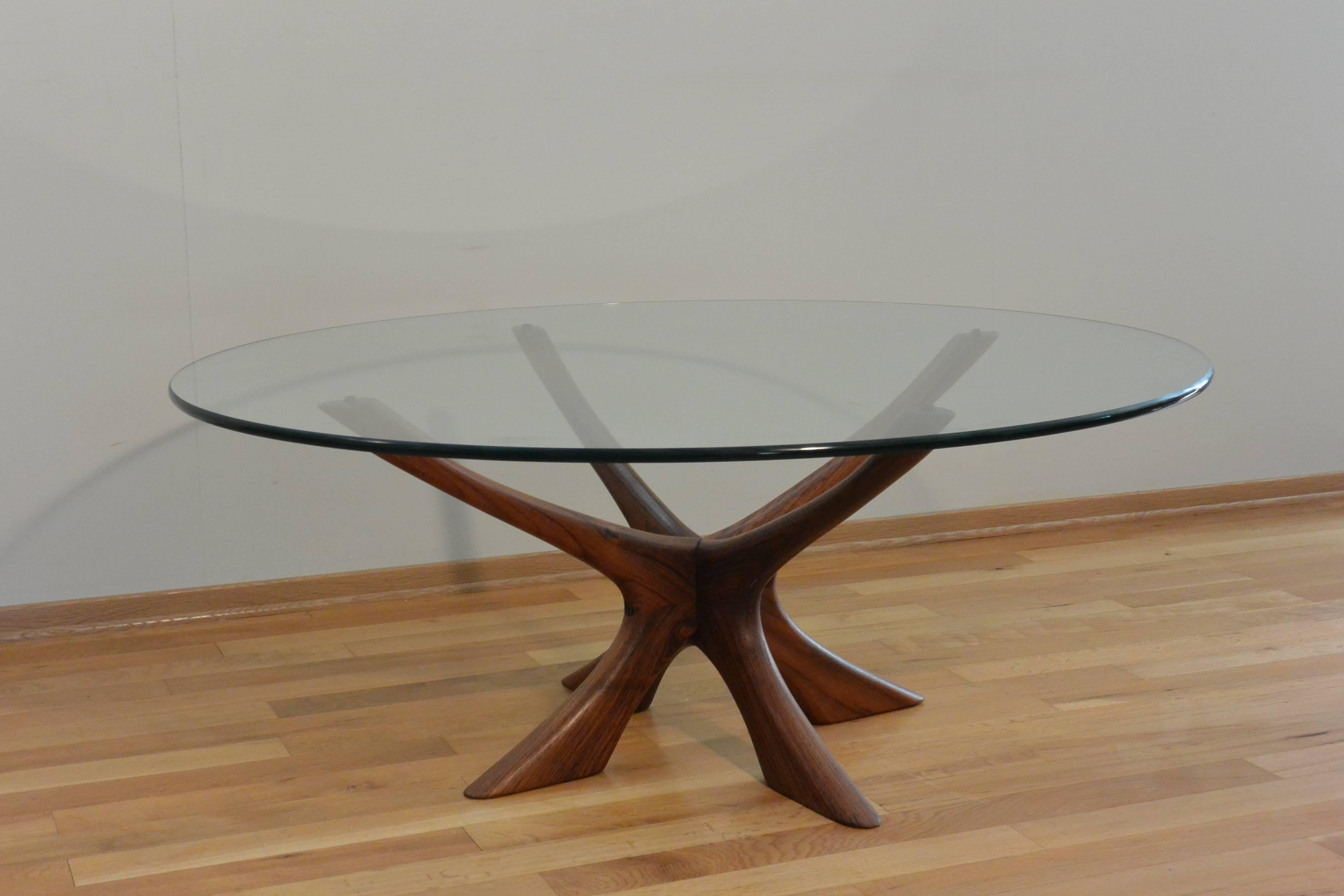 Elegantly sculptured teak base table with bevelled glass top was designed by Illum Wikkelso, Denmark, 1960s. Illum Wikkelso often designed practical and useful furniture with added focal theme. Some believe the base is modelled to resemble antlers,