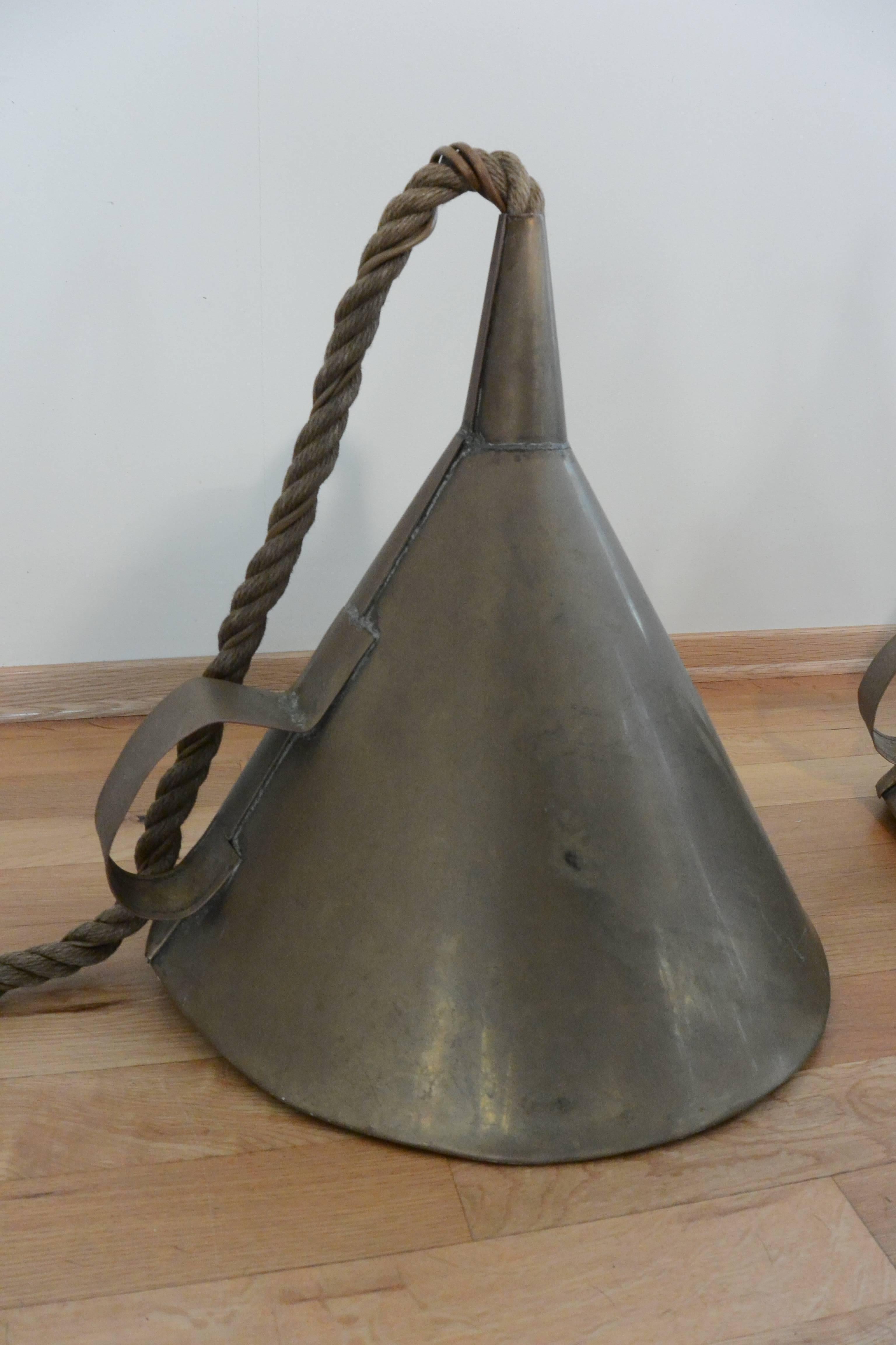 1970s solid brass and rope funnel pendant lamp shades removed from Norwegian business. 
 Lovely dull patina but can be cleaned to a high shine if desired. 
The pendants will look effective hanging up with the old vintage rope old and faded.
Each