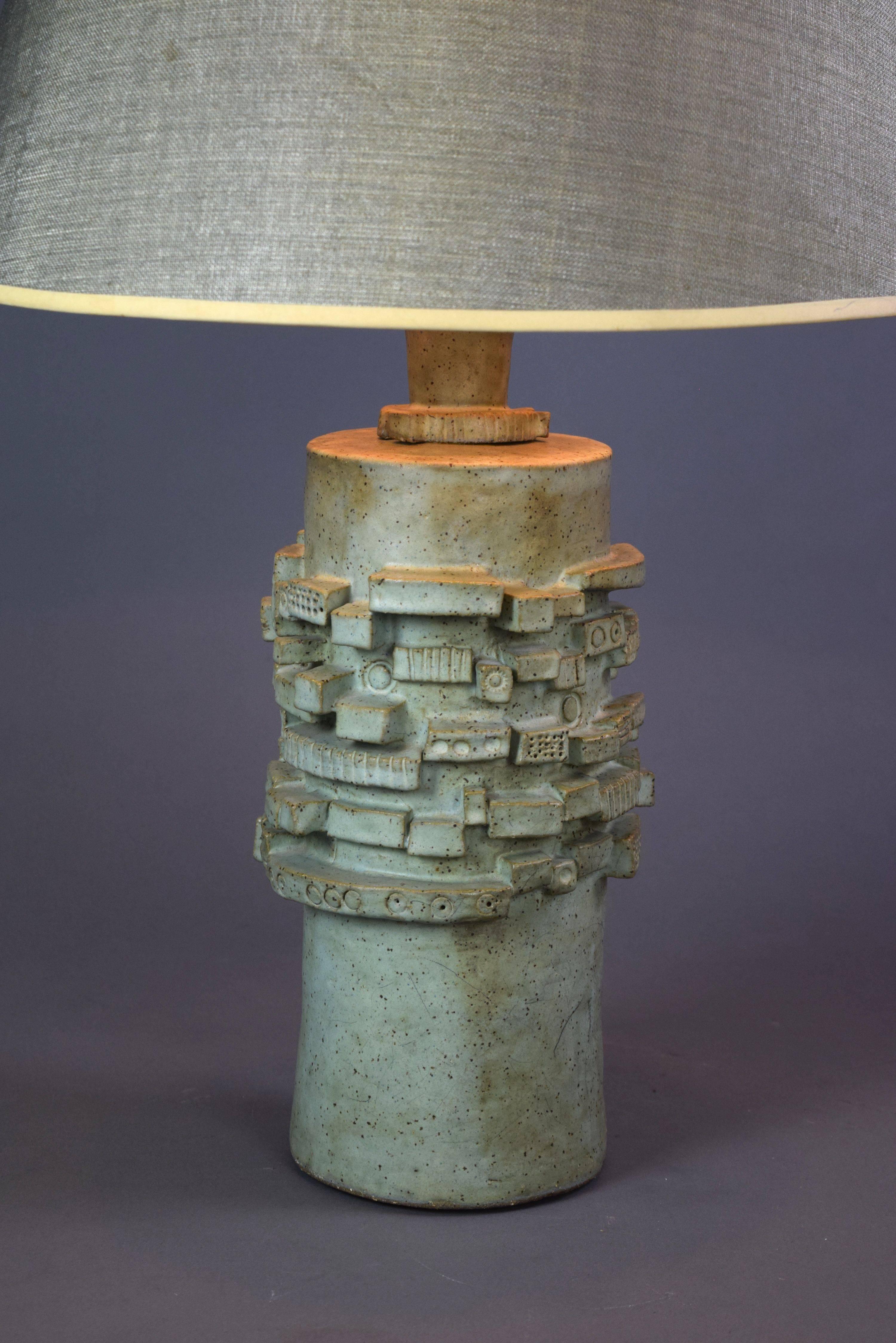 The round column lamp is centered by a high relief frieze composed of incised blocks.

Measures: Height To light fitting: 32.5