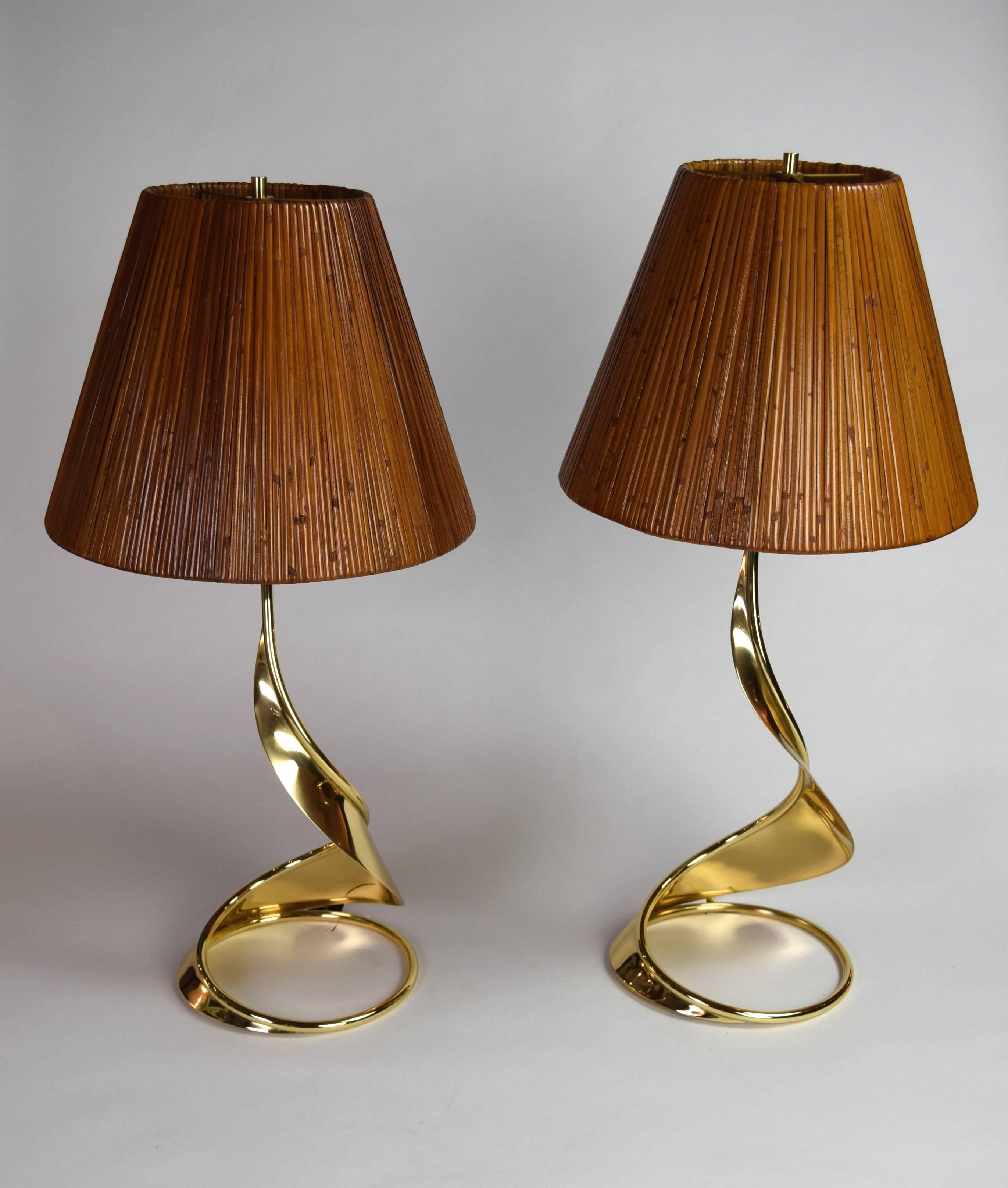 Each lamp has a circular ring base spiraling upward to support a bamboo shade. Incised with indecipherable signature.