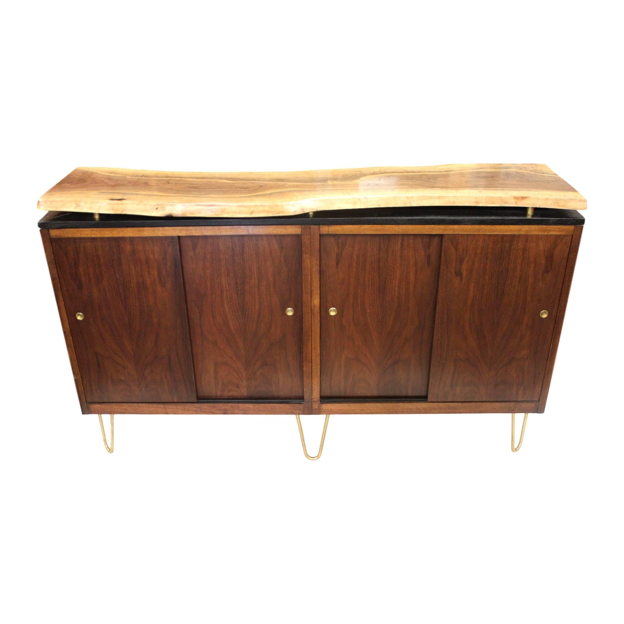Live-edge walnut slab credenza

This custom piece began life as a lack-luster 1970s steelcase credenza complete with severe finish damage and a very unfortunate Formica top. But one look at those gorgeous book-matched walnut sliders and we knew we