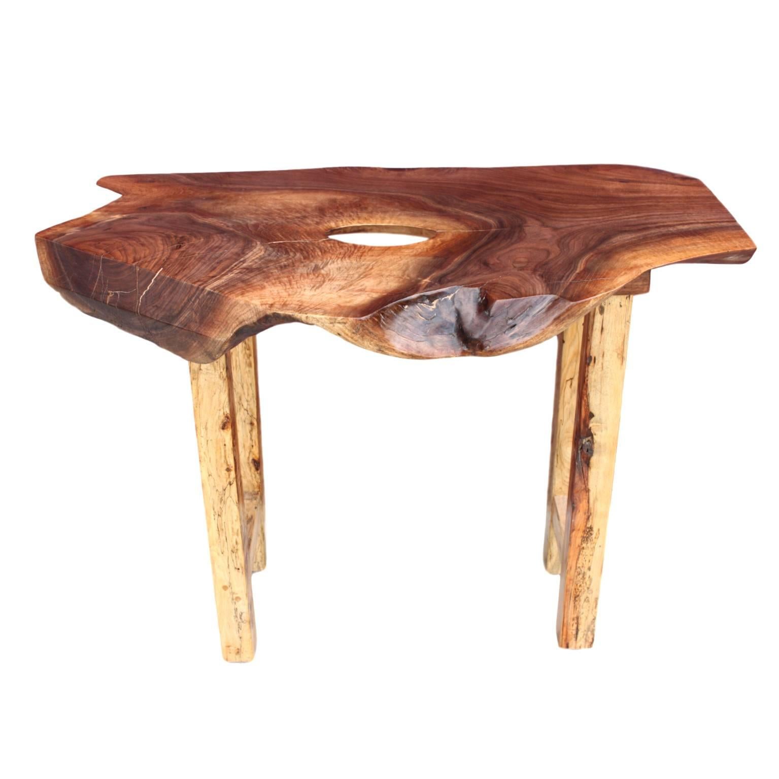 This wonderful little table was constructed in our workshop from solid walnut and maple. Top is a single 41" long slab of walnut retaining its wonderful organic edges on three of its four sides as well as a charming hole inclusion. A set of