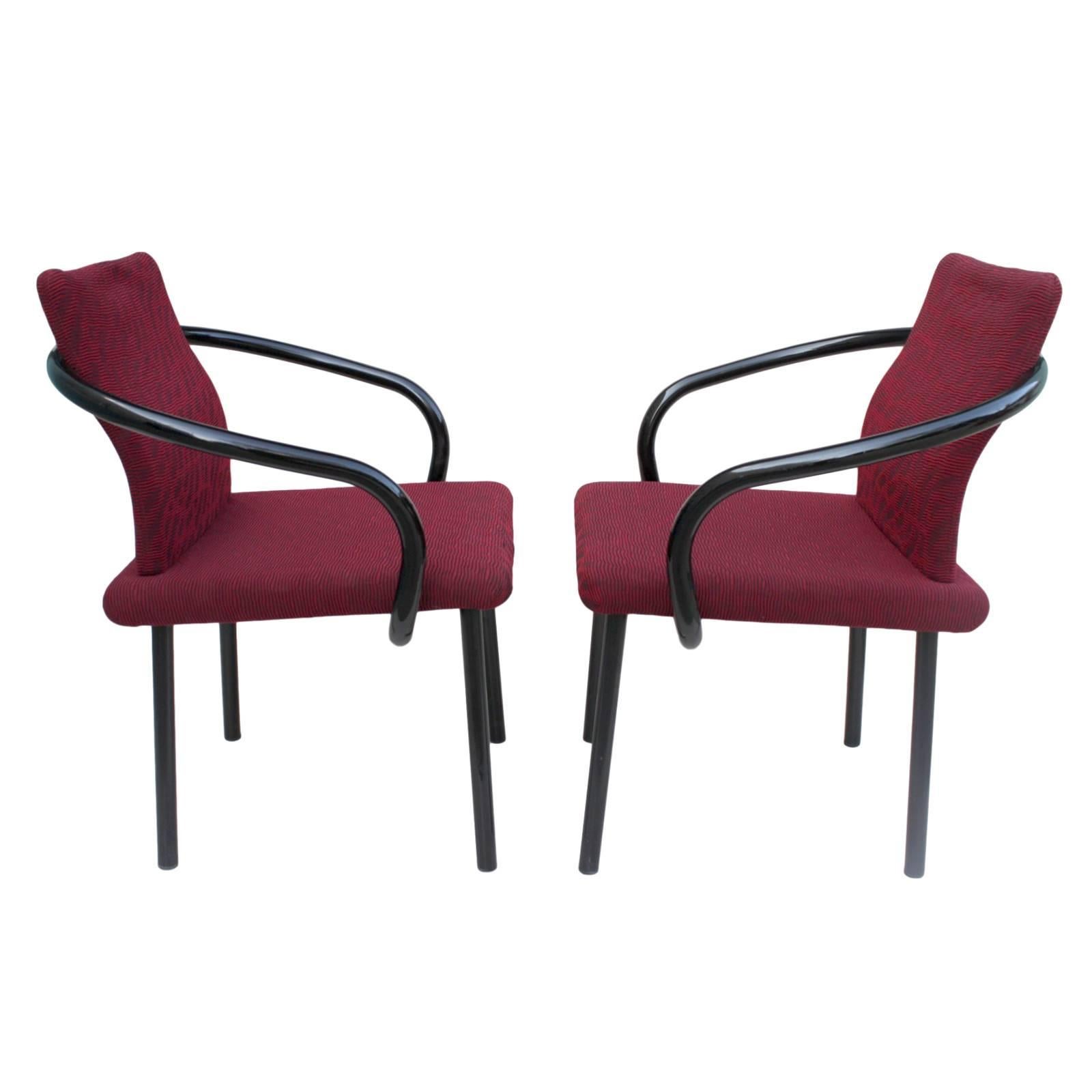 This awesome pair of of Manadarin side chairs is were designed by Ettore Sottsass for Knoll, chairs feature curvaceous tubular steel arms finished in gloss black, matte-black straight-tube legs and that fantastic original burgundy upholstery.