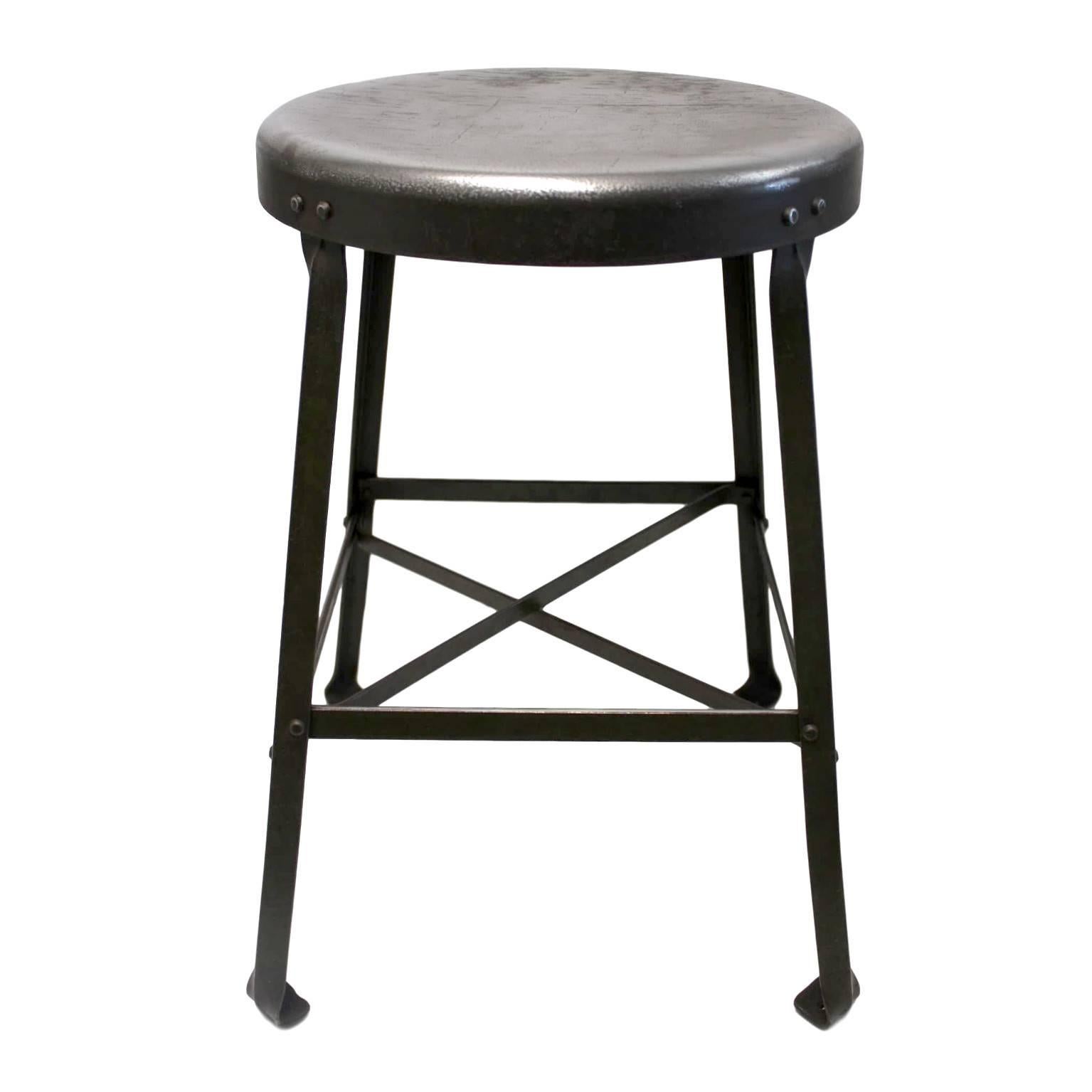 This great little stool was made by the Angle Steel Stool company and was used in a Pharmacy Dept lab at Purdue University its whole life. Stool features a heavy-duty, riveted, bridge-like construction and a gorgeous 70+ year worn patina to the