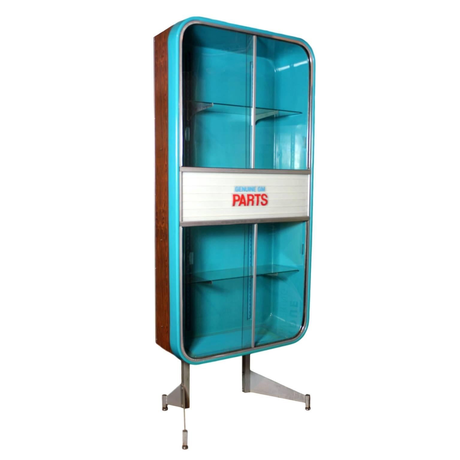 This seriously cool piece is a rare, original parts display cabinet from a 1960s GM dealership. Cabinet features a huge (36.5" x 71") turquoise vacuum-formed plastic tub wrapped in a faux-wood formica cabinet cantilevered over space-age