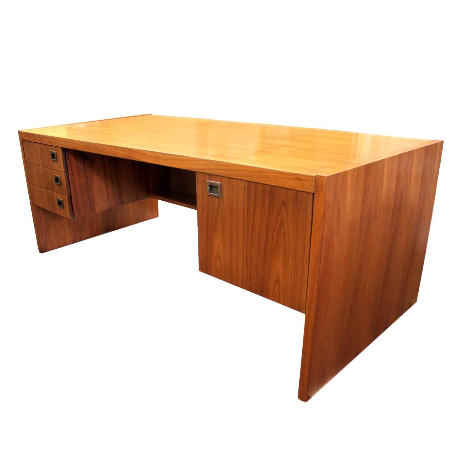 This magnificent, matching executive office set is attributed to Jens Risom. Both desk and cabinet are done in Risom's iconic Minimalist style allowing the gorgeous book-matched walnut veneer to take front-stage. Hardware on both pieces are