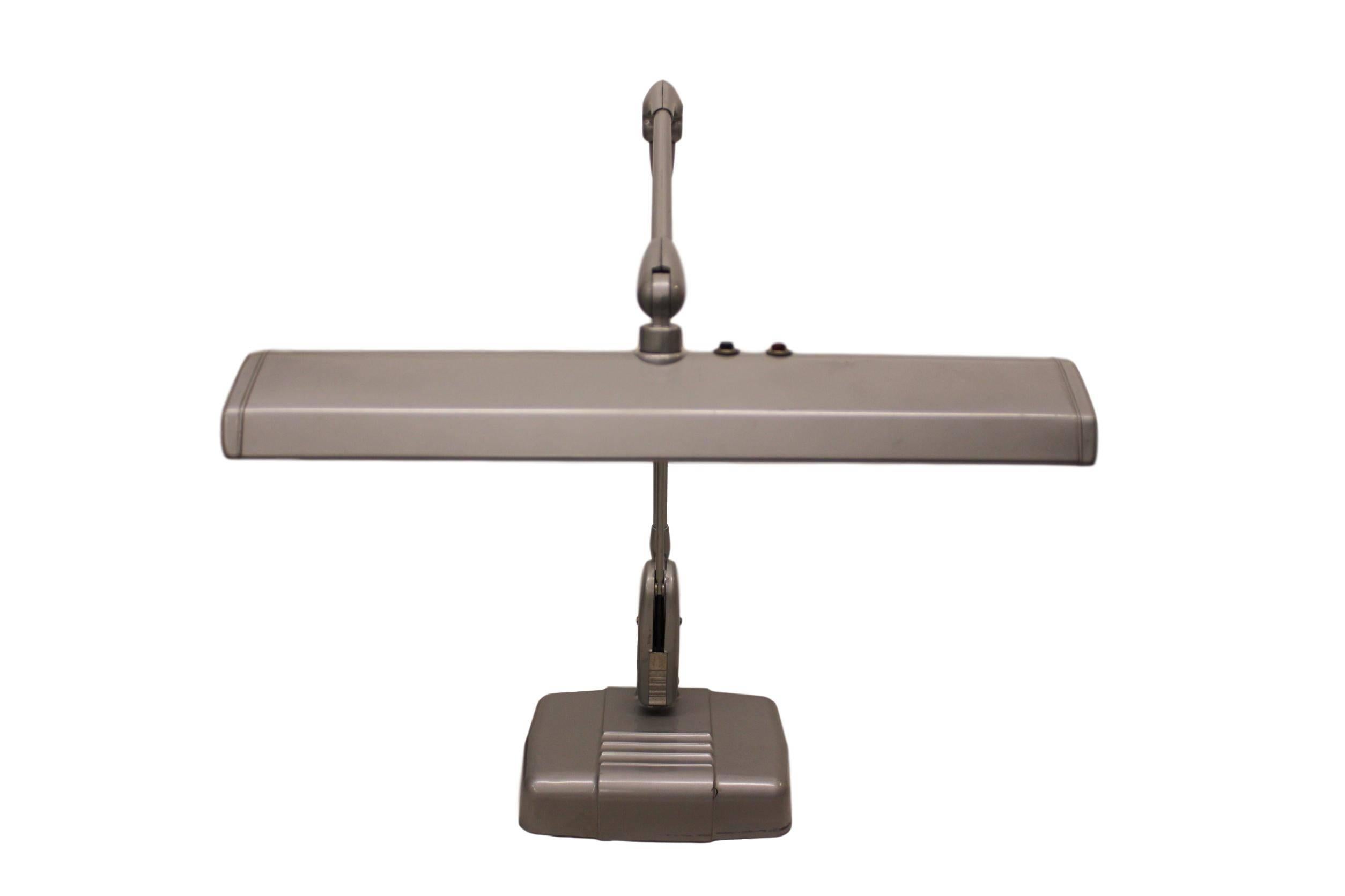 This lamp is a timeless piece of Mid-Century Modern Industrial Design and features the hard-to-find, original silver paint that really sets off the form beautifully. However, this lamp has function to match its form with a weighted base and