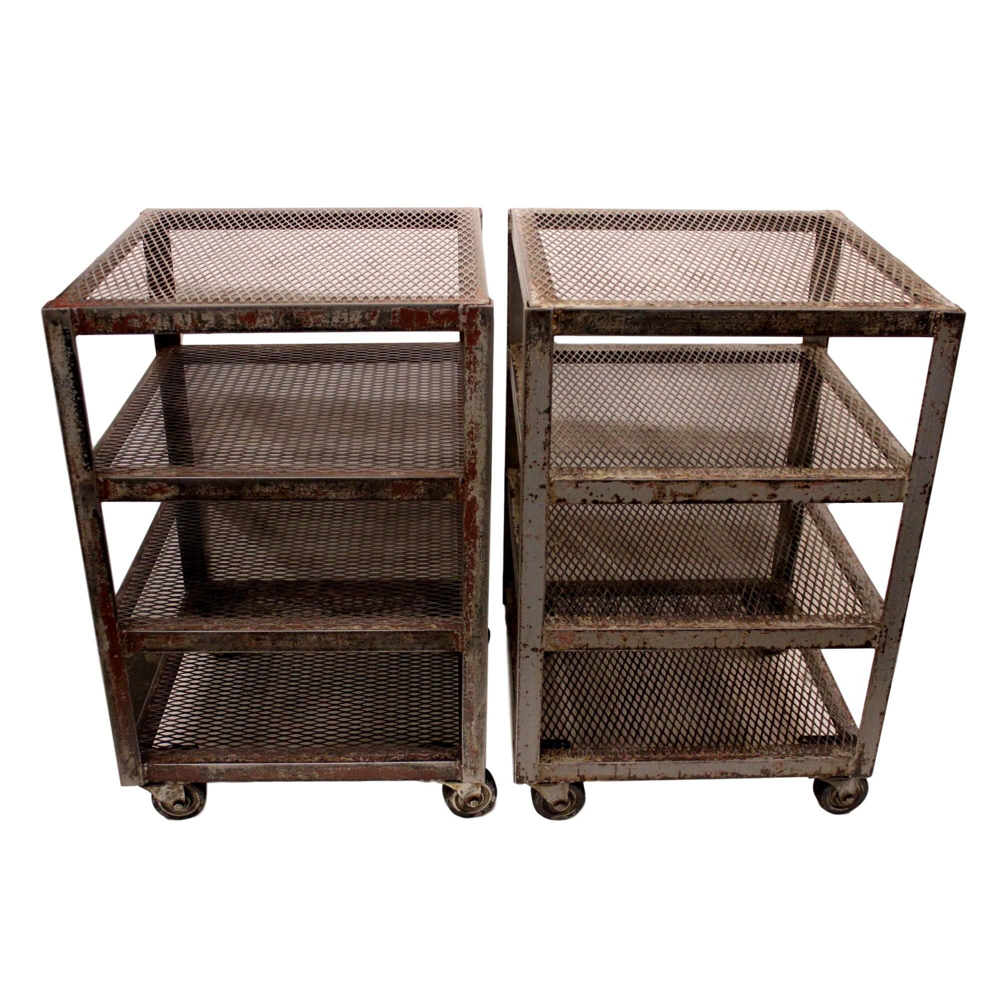 This wonderful pair of vintage factory carts feature solid steel construction with a beautifully worn painted patina (browns and grays) and 4 steel mesh shelves. Carts are a great size and feature wheels for even more versatility.