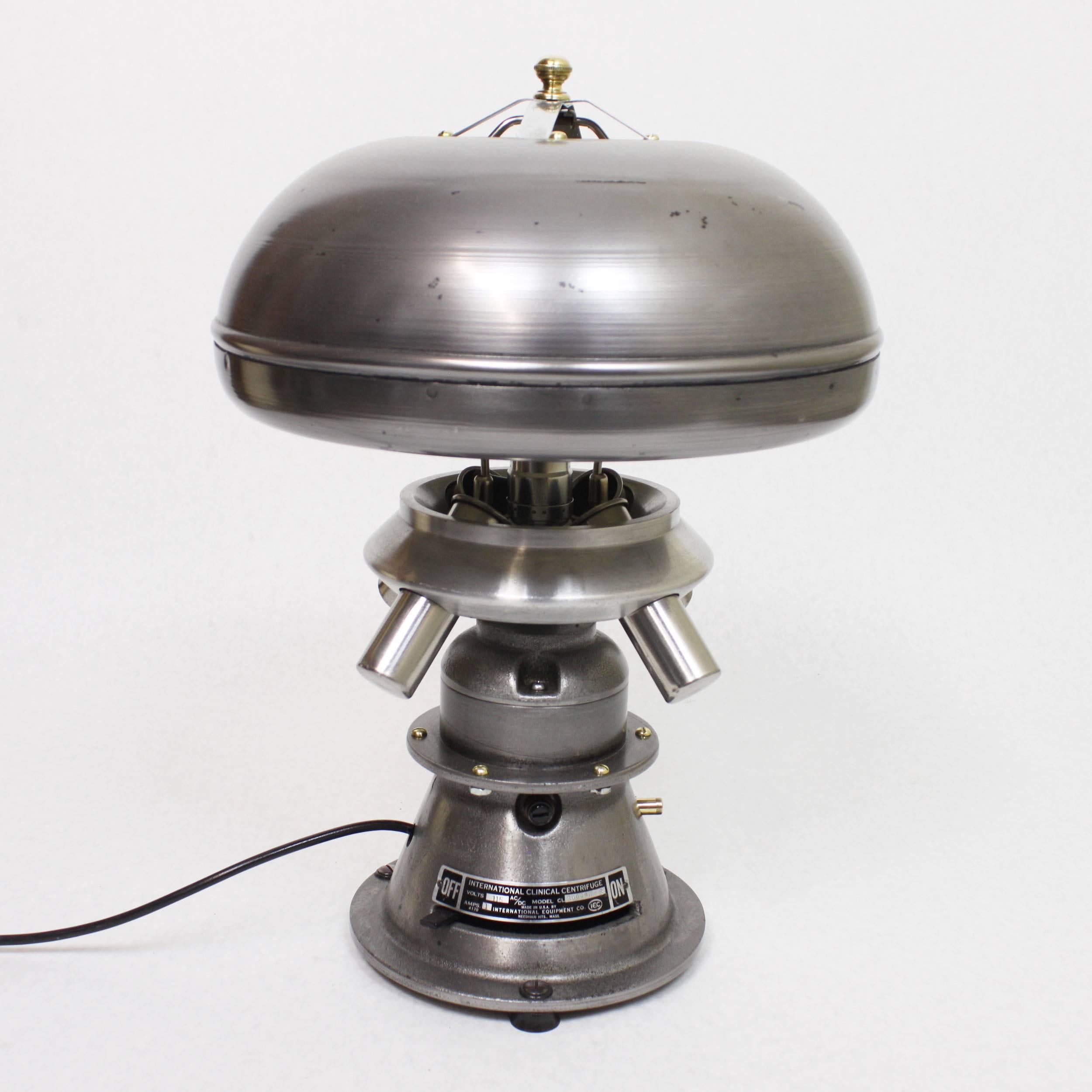 This fantastic little lamp began life as a vintage laboratory centrifuge and has been ingeniously re-purposed in our workshop as this beautiful Industrial table lamp. The centrifuge body was removed from the base and inverted to form a charming