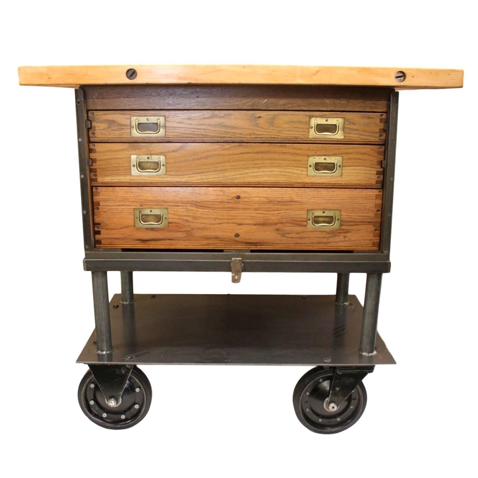 This piece began life as a WWII era field engineer's cabinet, was modified in the 50's with a custom rolling base and has been finally re-imagined with butcher block top to create a wonderful little Industrial kitchen island.  Both the cabinet and