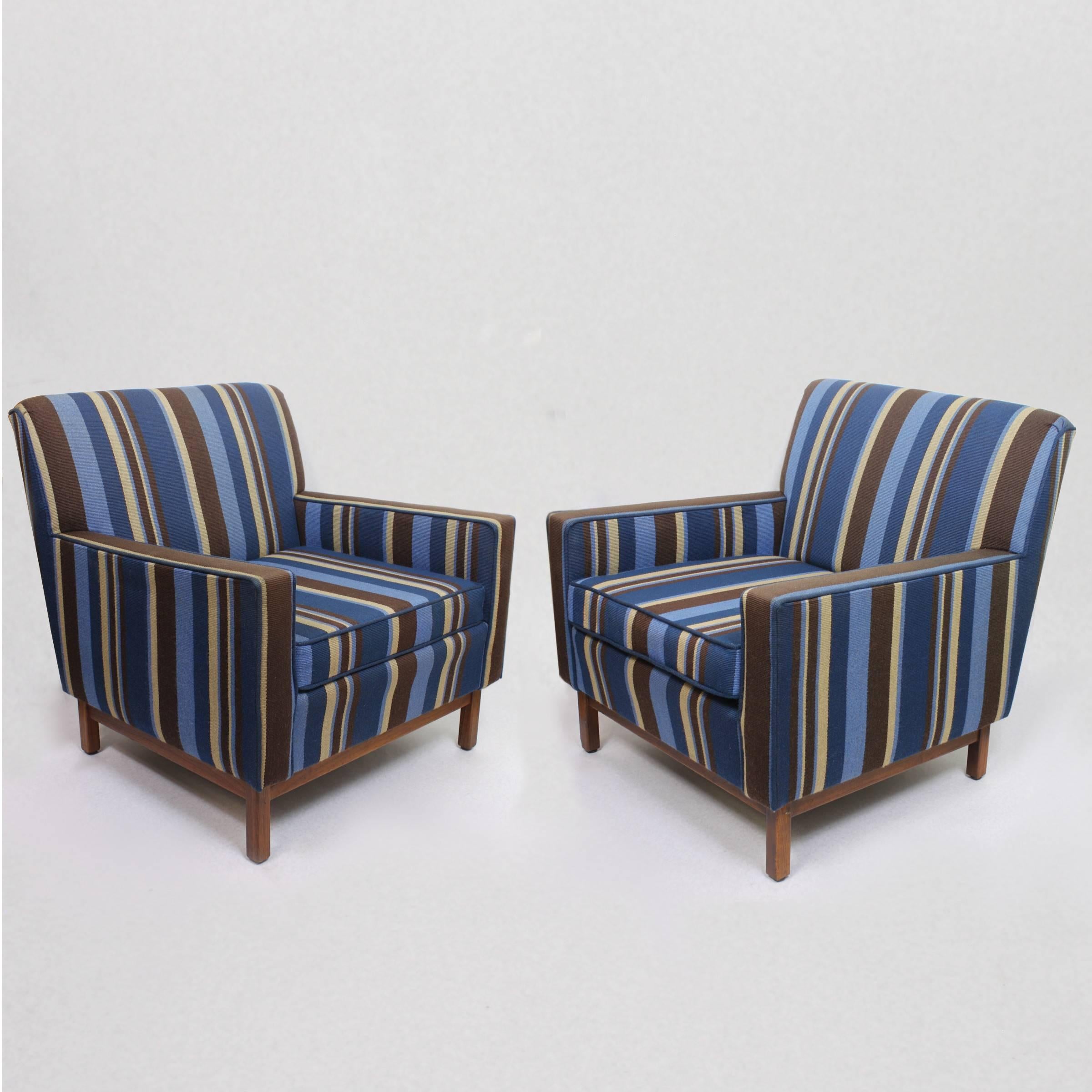 This wonderful set of matching vintage club chairs were manufactured by the famed Gunlocke Chair Company of Wayland, NY. Chairs feature a fantastic original wool upholstery with vibrant navy blue, sky blue, mocha brown, and tan stripes. Chair bases