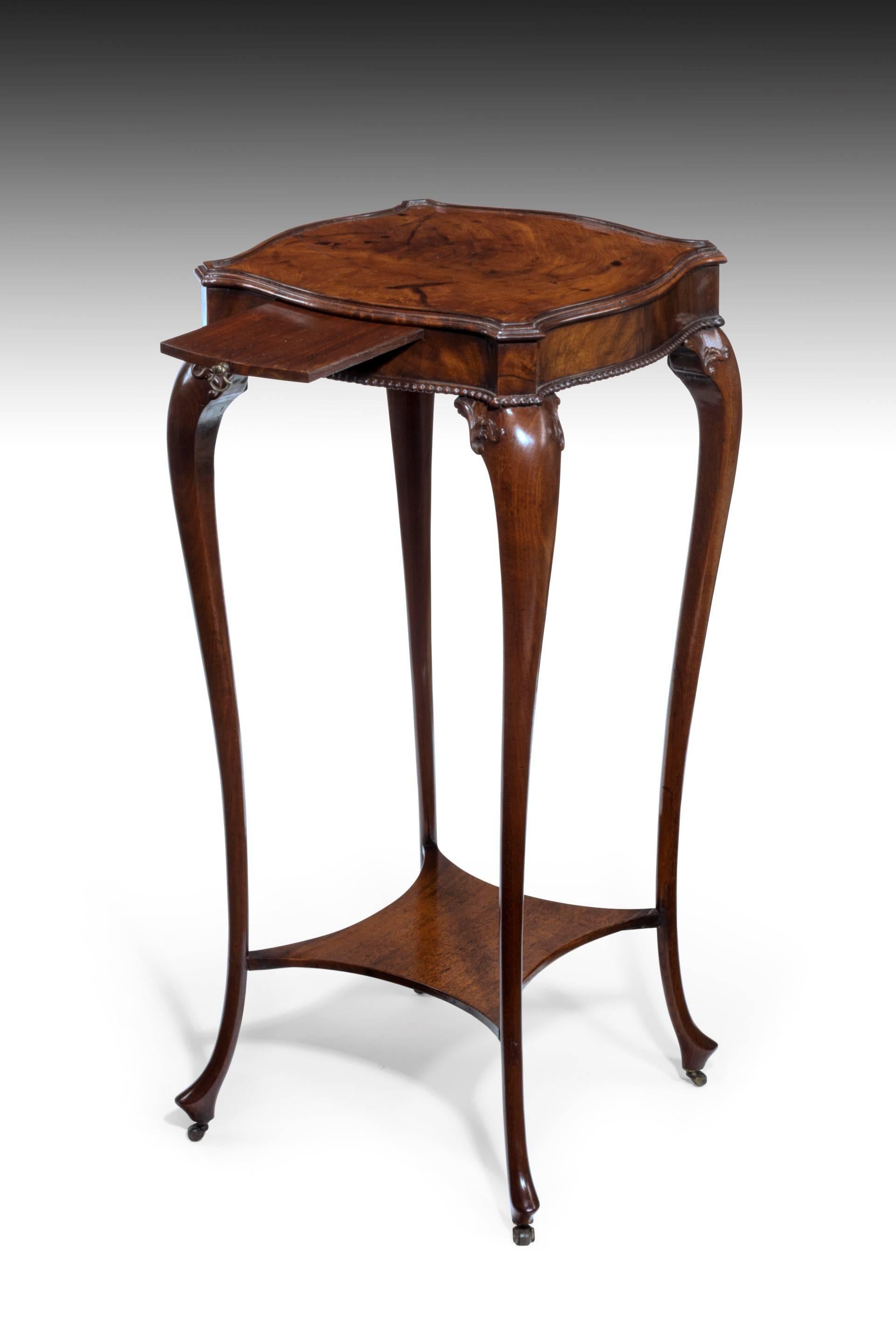 A Fine George III period carved mahogany urn table. With a serpentine square top with a moulded edge over a shaped frieze and bead moulded border, one side with pull-out slide with brass axe-head handle. The well drawn and beautifully slender
