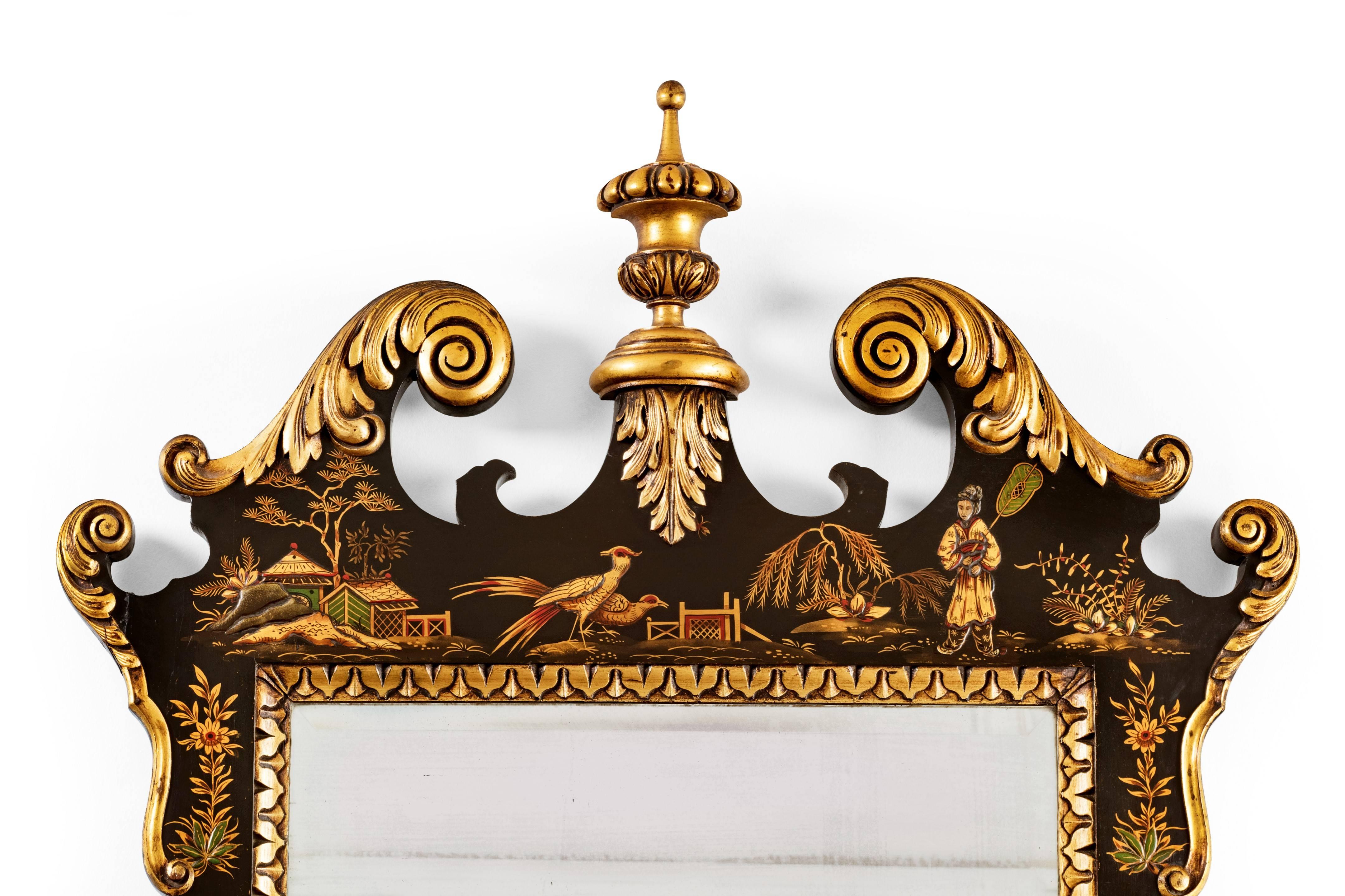 A superb quality and finely executed gilded and black japanned mirror in the early 18th century Baroque style, with a bevelled edge glass.