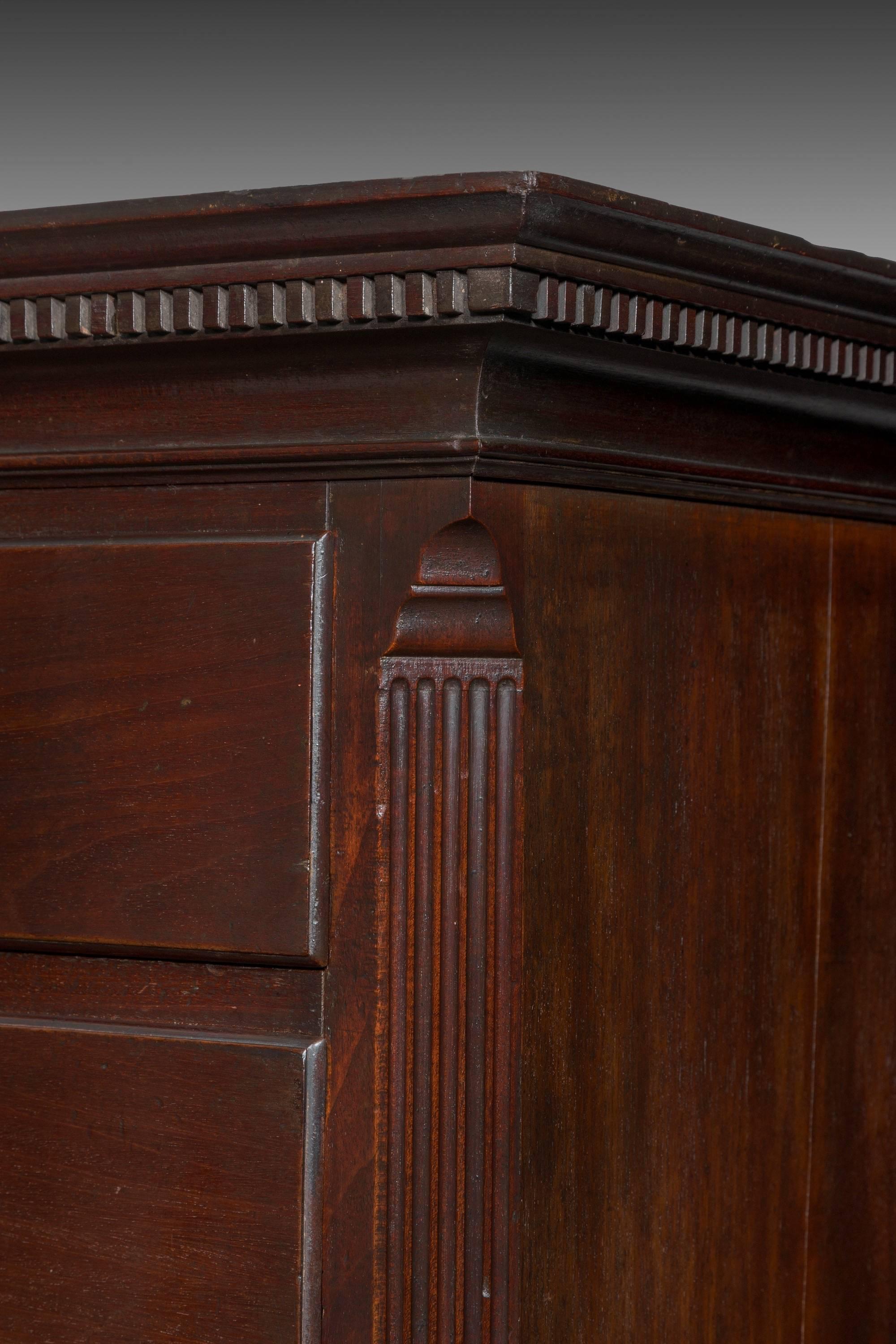 A stately and rather rare George II period mahogany tallboy chest on press. An absolutely super example of mid-18th century design and cabinetmaking. The dentilled cornice crowns the top section of drawers with wonderful Chinese Rococo mounts,