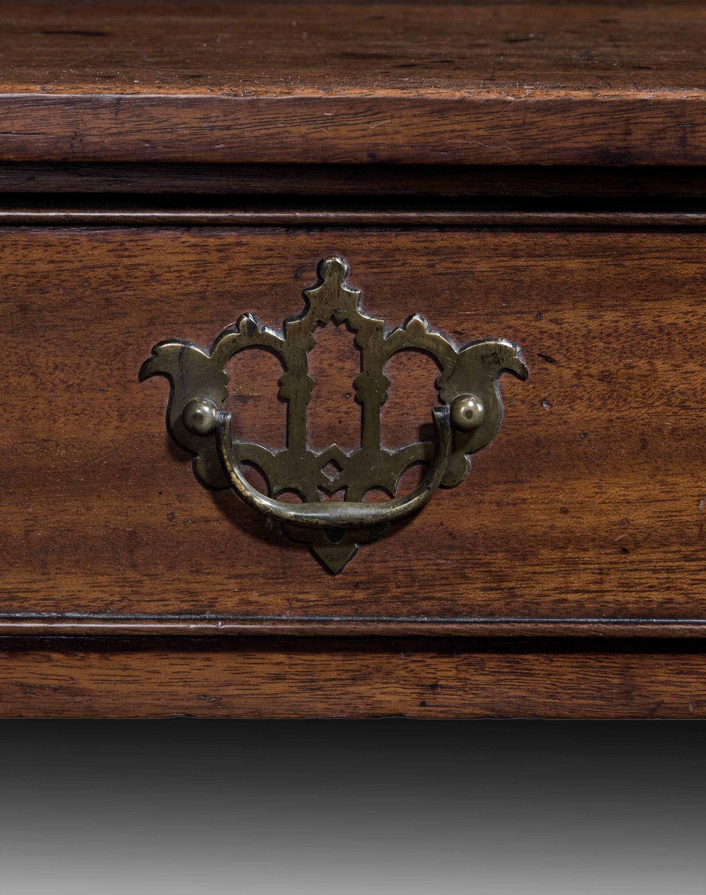 A George III period mahogany singe drawer side table, with original Chinese Rococo brass open plate handles.