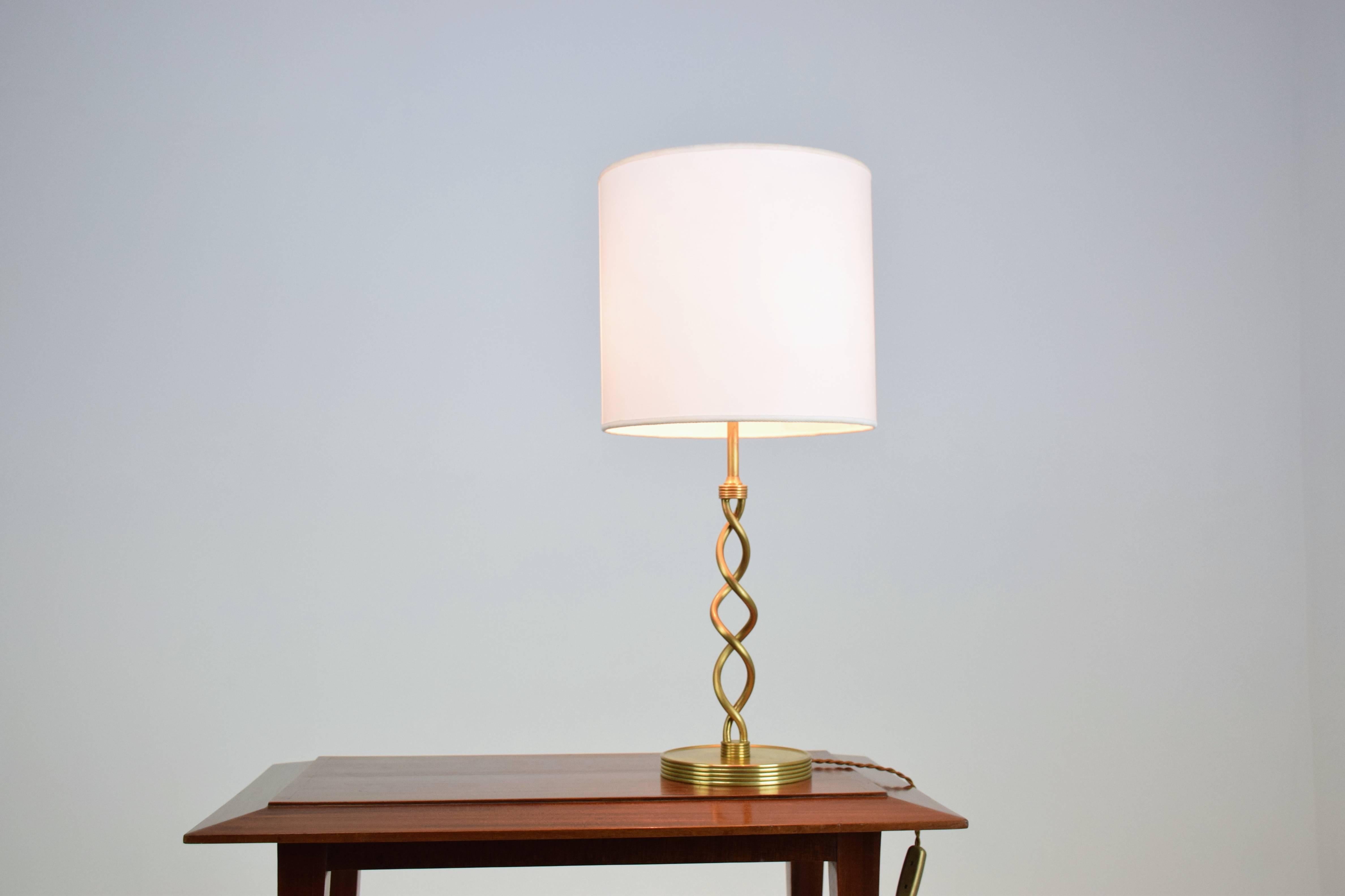 20th century sophisticated French table lamp with twisted solid brass detail, circa 1960s. Restored through polishing rewiring and quality new shade.
      