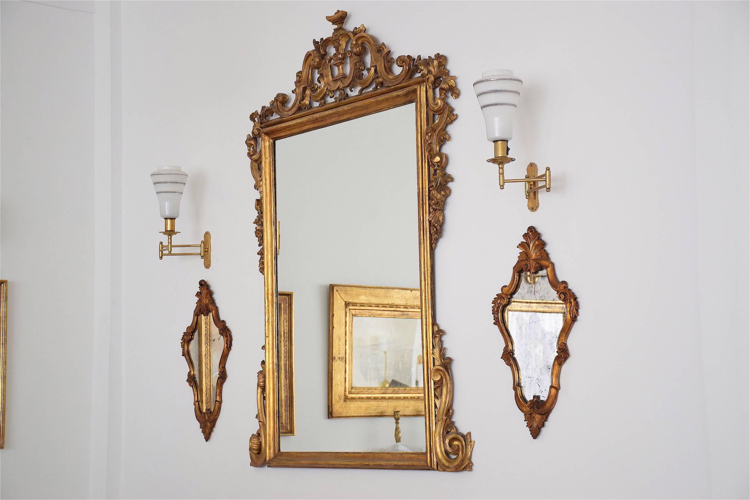 Pair of Italian Rococo style wall mirrors composed of giltwood with delicate leaf motifs and available in their original glass.
Italy. Beginning of the 1900's. 
-----
All our pieces are fully restored at our atelier and we only offer items that will