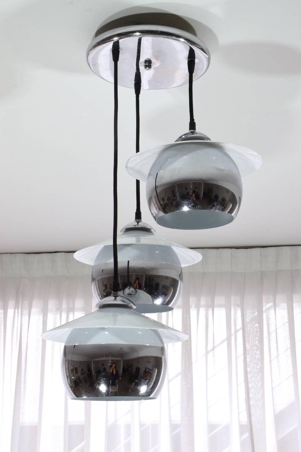 20th Century Italian pendant designed with three hanging chrome and glass spherical shades.