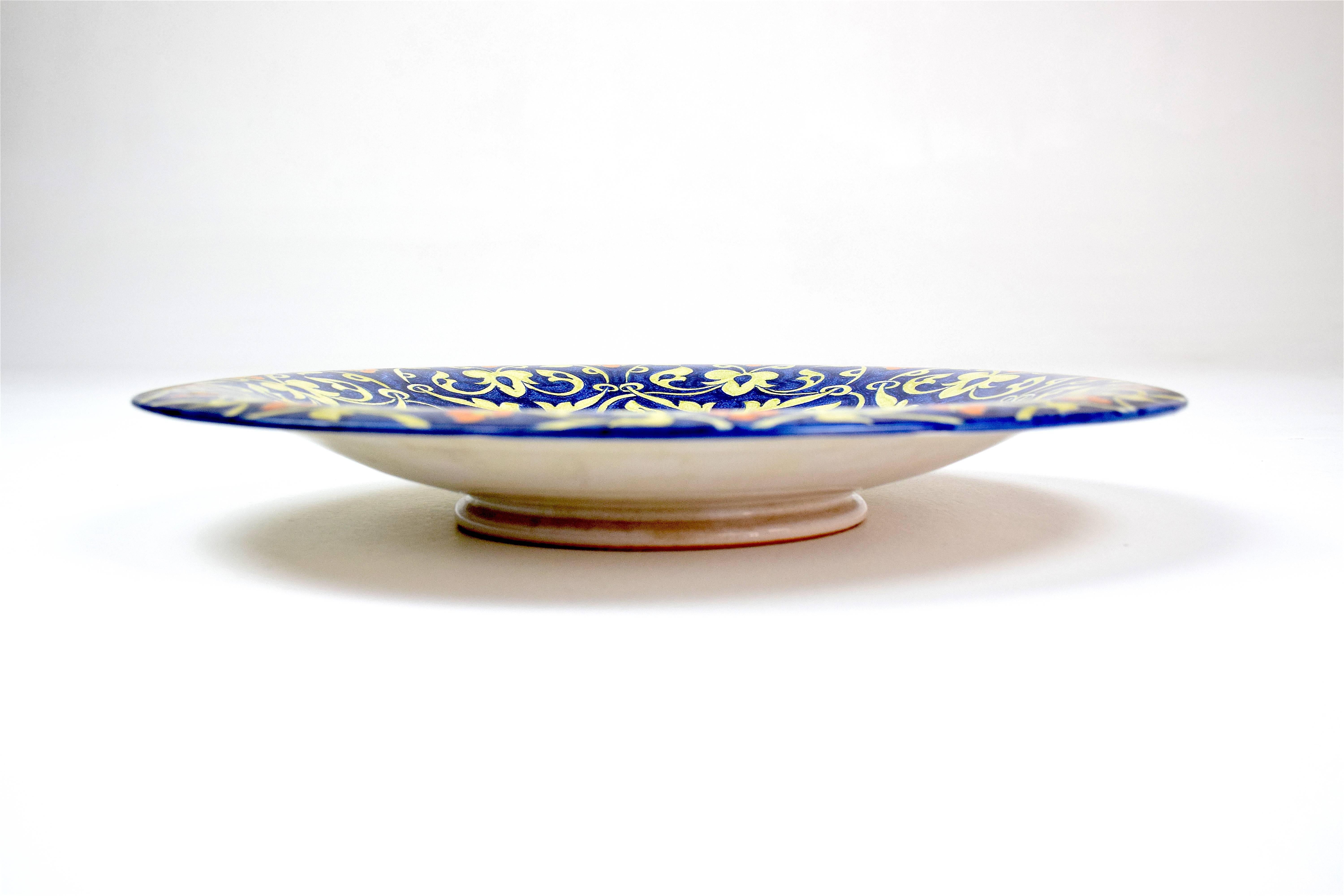 A beautiful hand painted Italian ceramic decorative dish, vide-poche or centerpiece with flower motifs in yellow blue and orange. It was handmade in the region of Perugia, Italy. Signed 