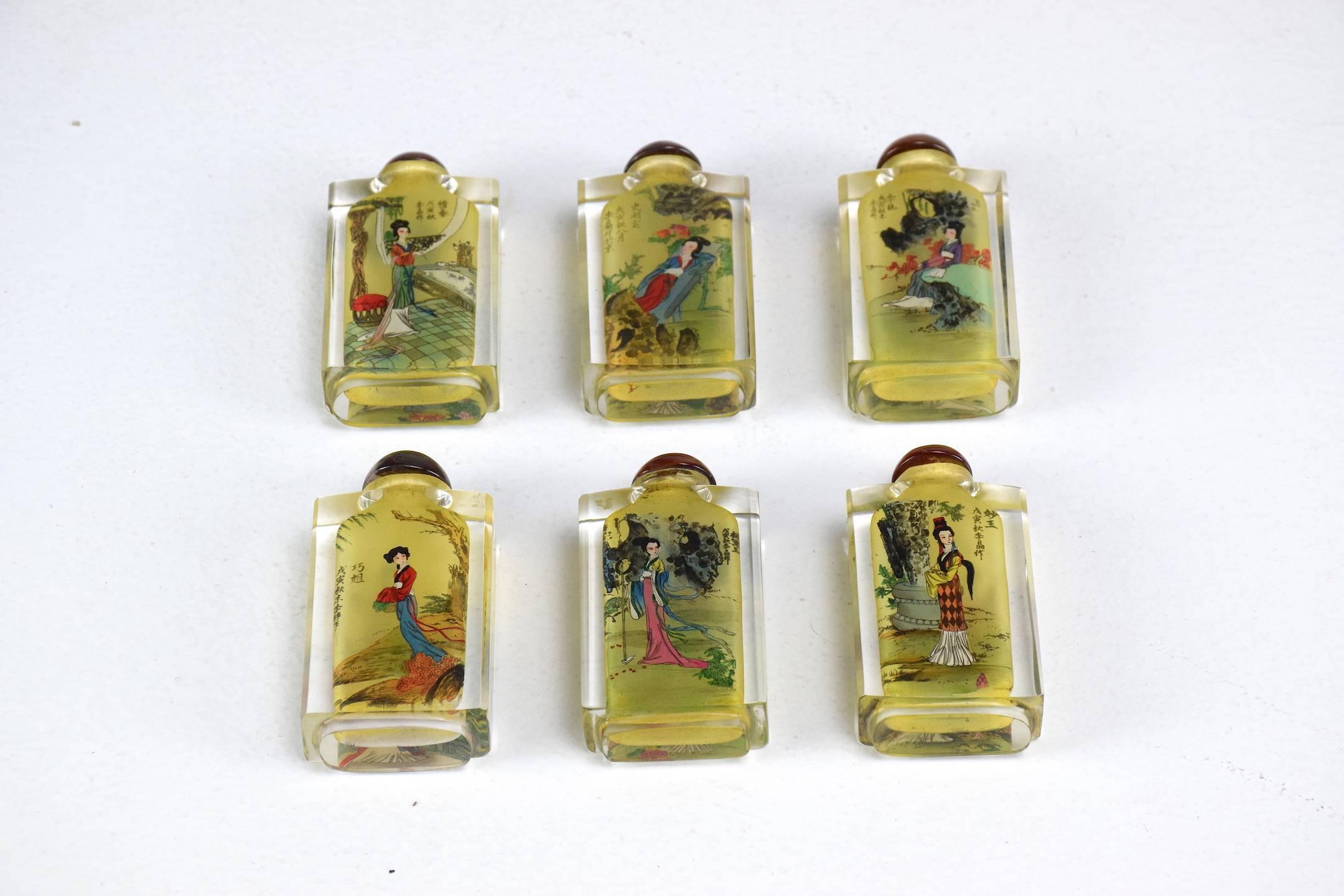 Chinese handcrafted inside painted crystal cut snuff bottles in set of six. Each bottle is composed of two different paintings on each side. All in excellent condition.