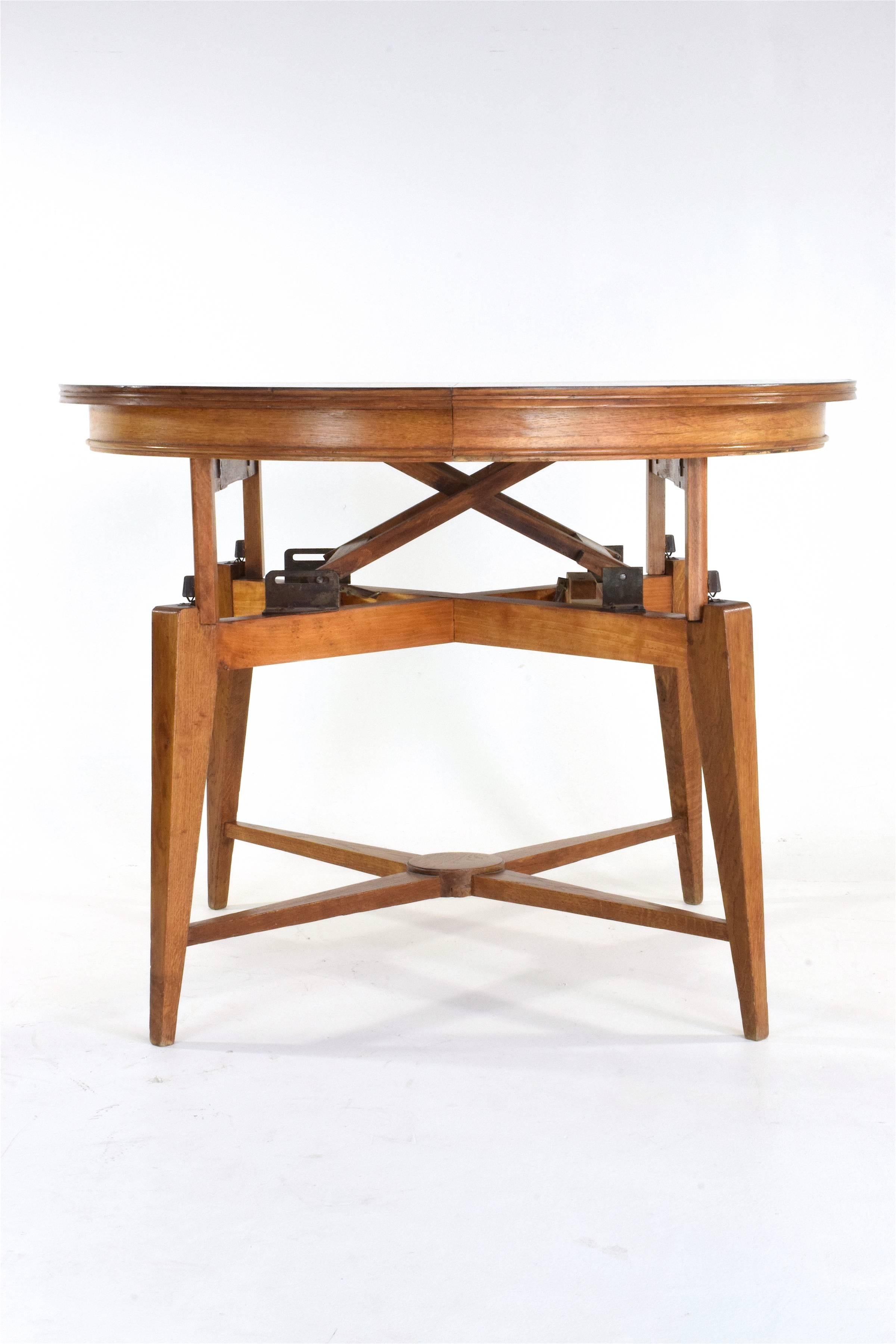 A historic Marcel Gascoin adjustable and convertible coffee, center or small mechanical dining table composed of solid oak.
Max height: 72cm 
Minimum height 56cm 
------

We are an exhibition space and an online destination established by the