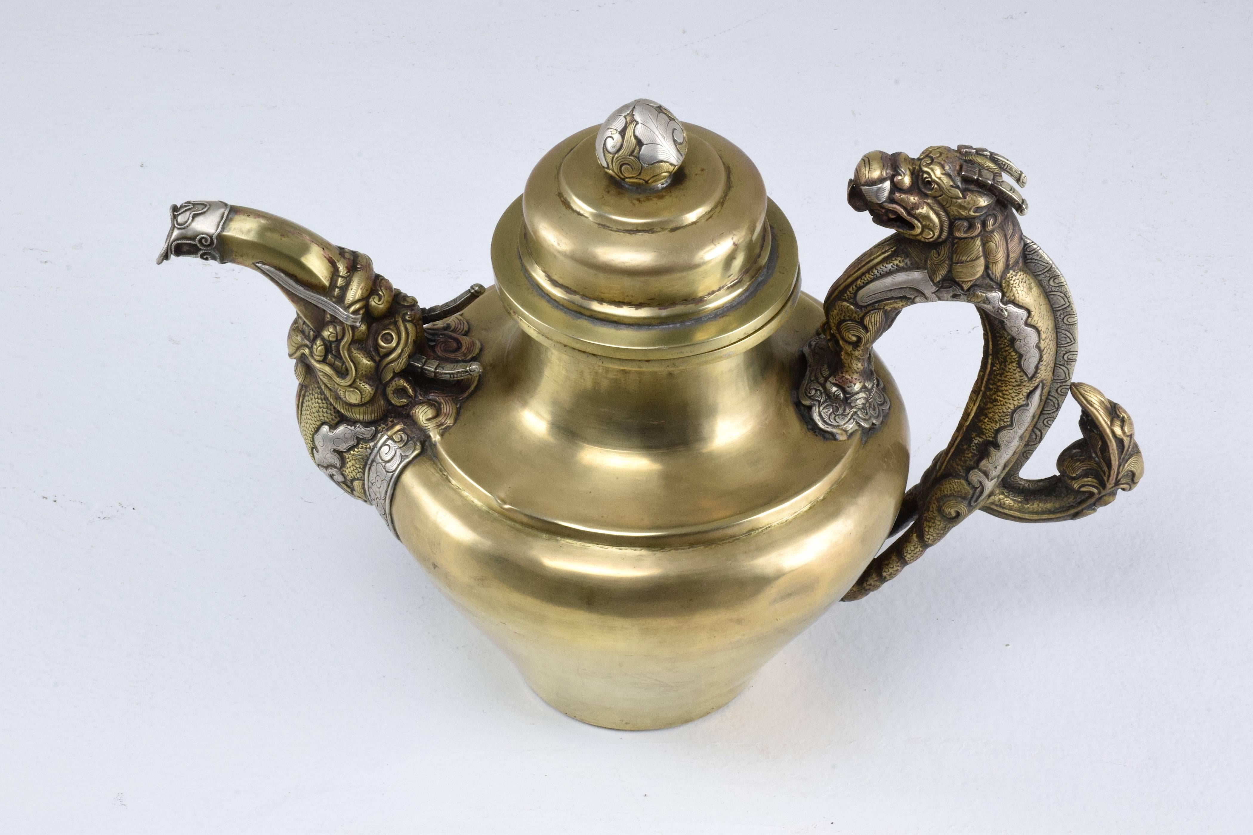 Astounding 18th-19th century Tibetan brass and solid silver teapot with intricate hand carved and sculpted details of dragon ornements. 
Purchased more than thirty years ago by our gallerist in the country.
We recently polished it to highlight its