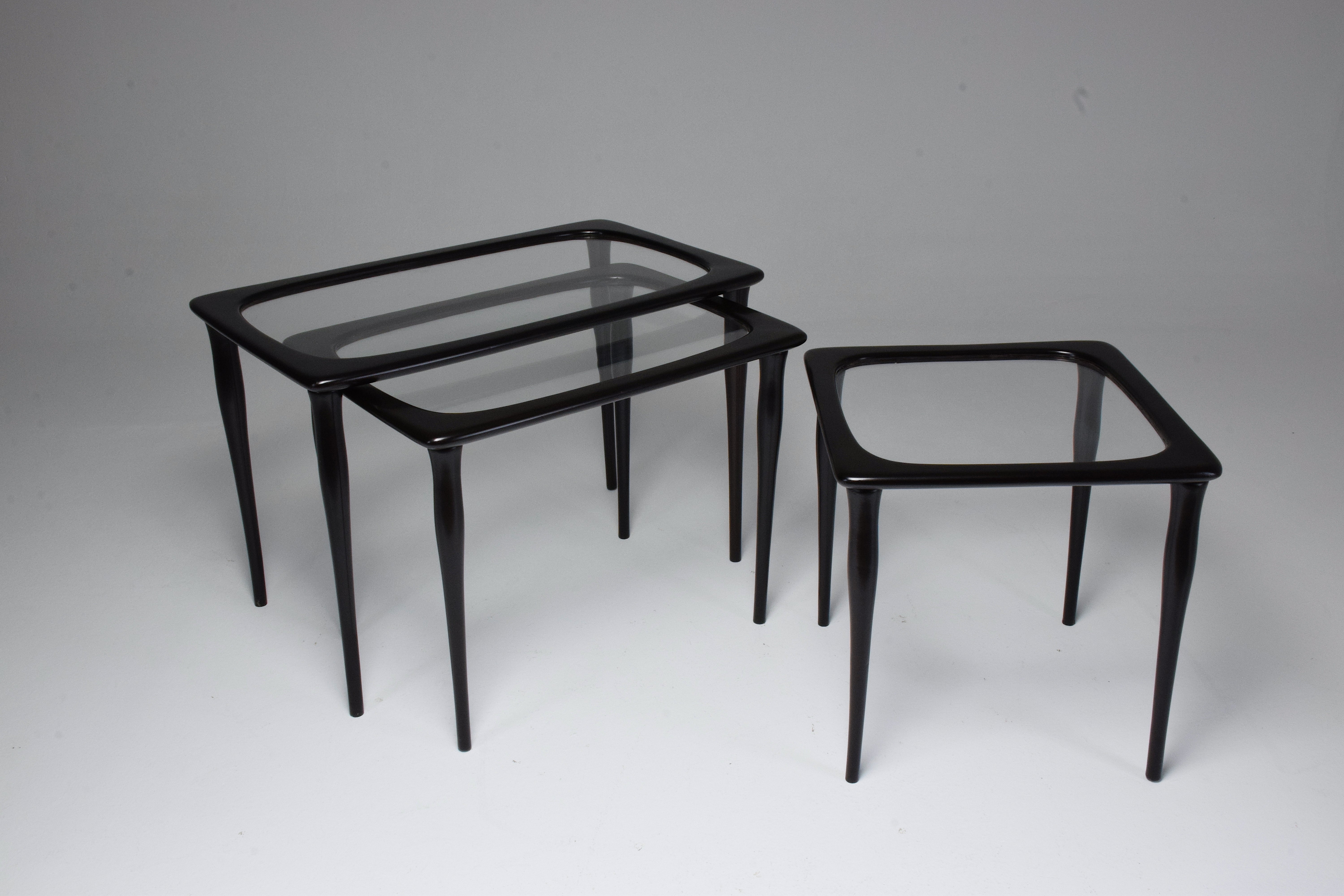An exquisite set of three vintage nesting side or coffee tables, crafted by the renowned Italian furniture designer Ico Parisi in the 1950s. They are a testament to Parisi's visionary approach to furniture design, characterized by sleek lines and