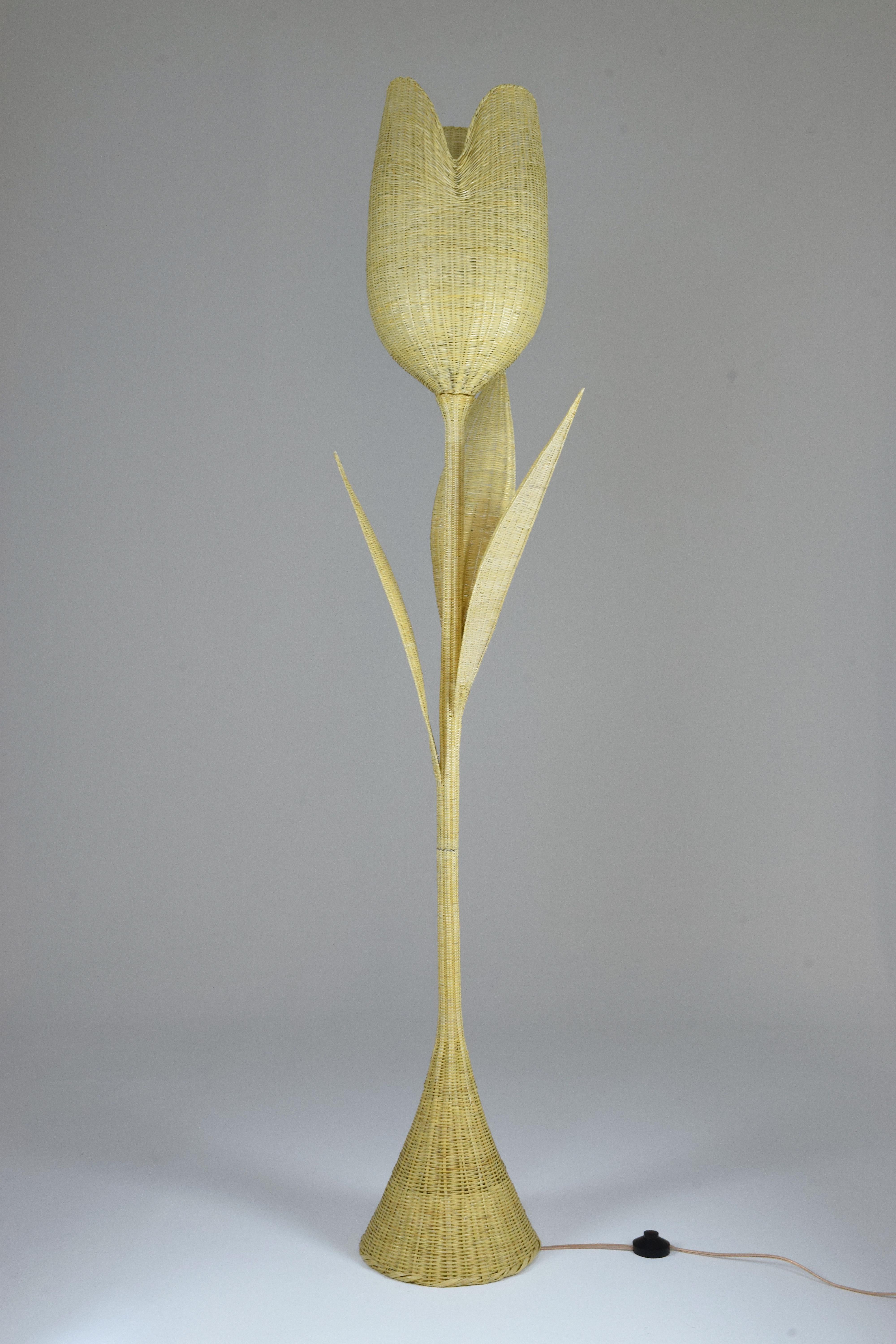 An exceptional handmade floor lamp entirely handwoven in naturally sourced wicker. This rare form of workmanship takes a month to craft and requires countless hours of meticulous work. The wicker vines are peeled by hand using a knife to extract the