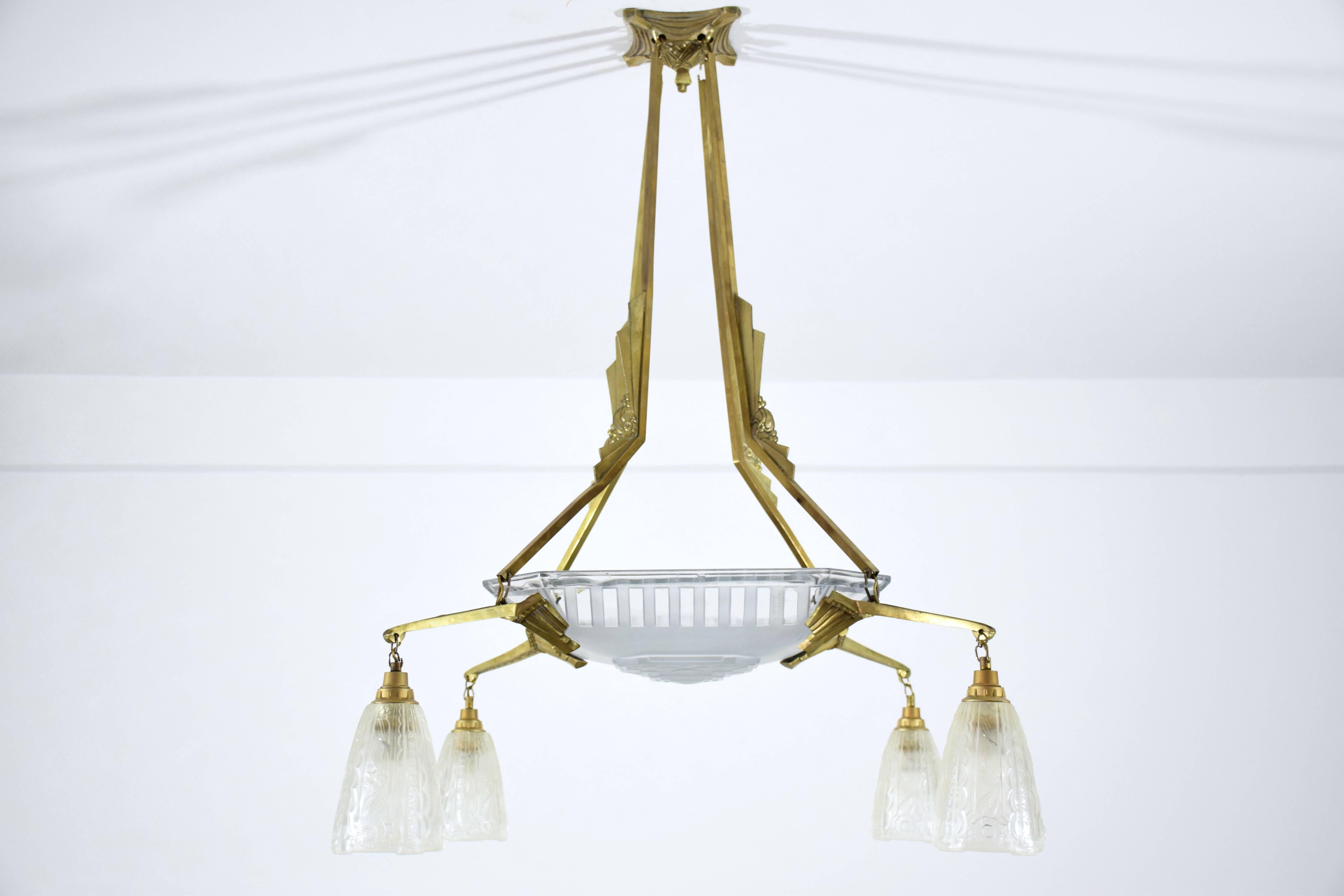  20th Century vintage French chandelier chandelier signed Freres Muller Luneville composed of an intriguing winged bronze structure and four moulded frosted glass shades. 

This creation is an example of the Frères Muller's evolution into the Art