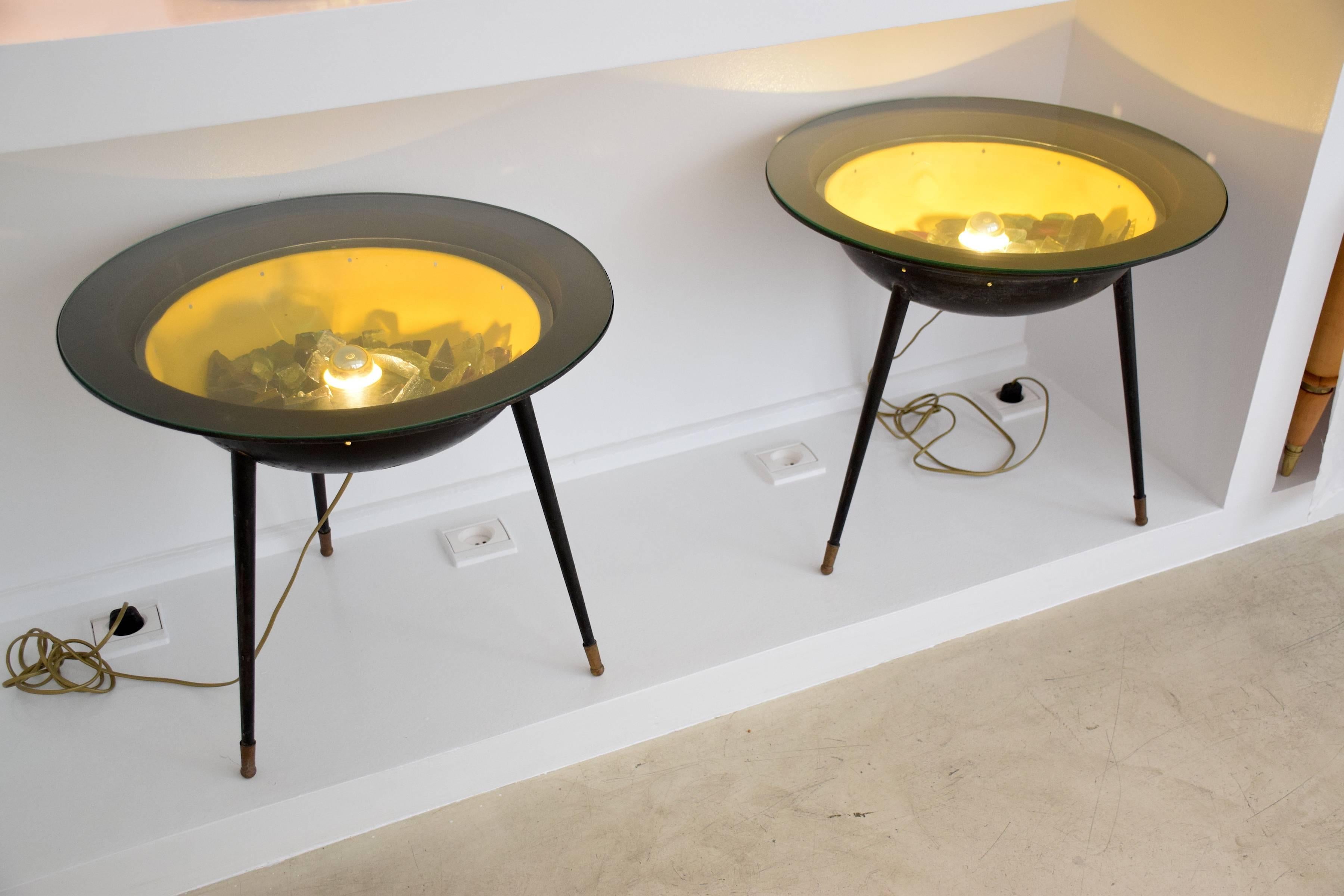 A pair of french 20th century vintage circular side or end coffee tables in mid-century Space Age style.
Both circular shaped collectible tables with glass tabletops are equipped with integrated lighting highlighting the different coloured