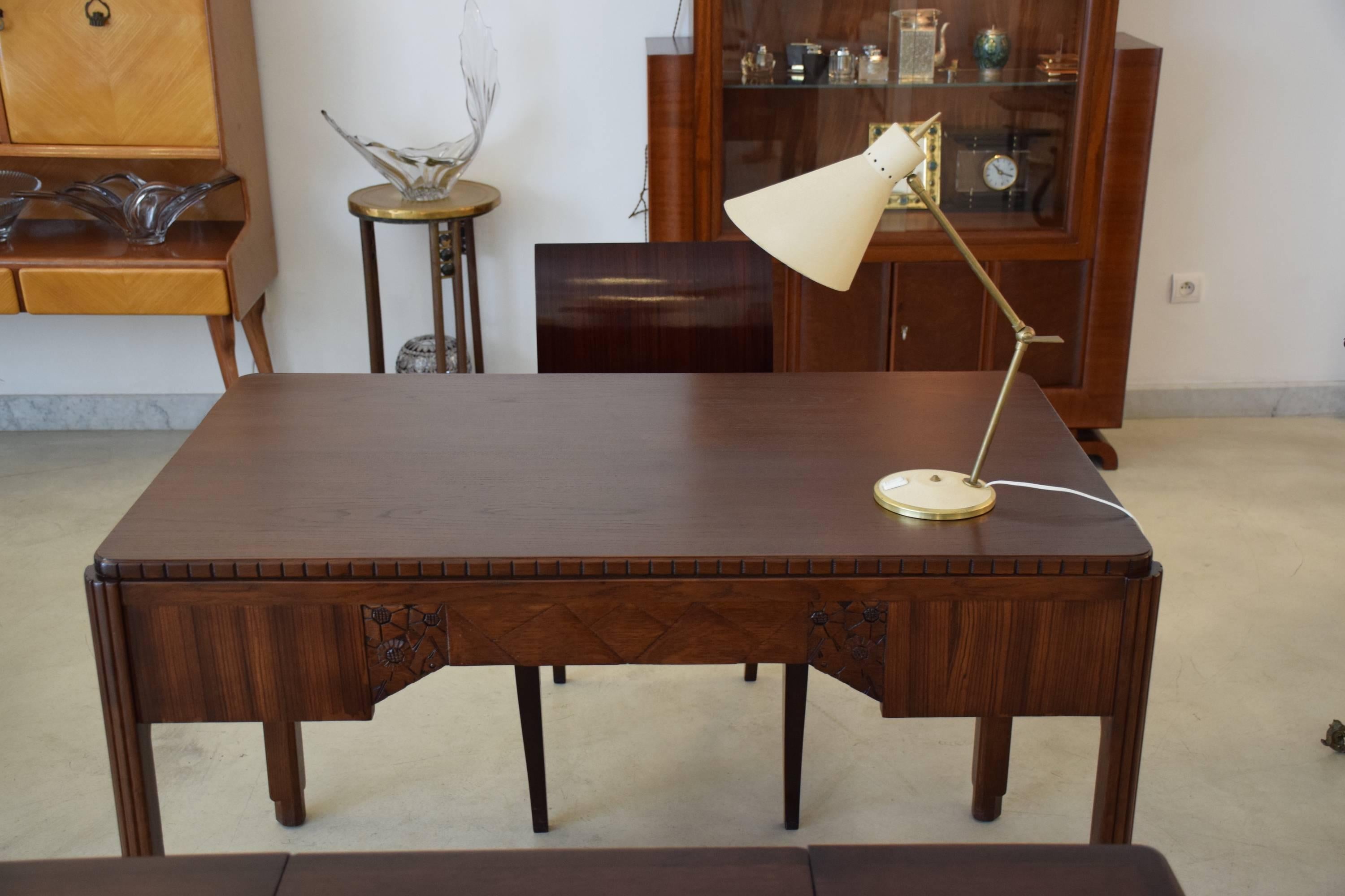 A stunning 20th Century Art Deco desk with a solid oak top, legs, drawers and zebrano veneer. The desk has beautiful sculpted flower details at the back, fluted legs and brass key details on each drawer. 

All original pieces, apart from the backs
