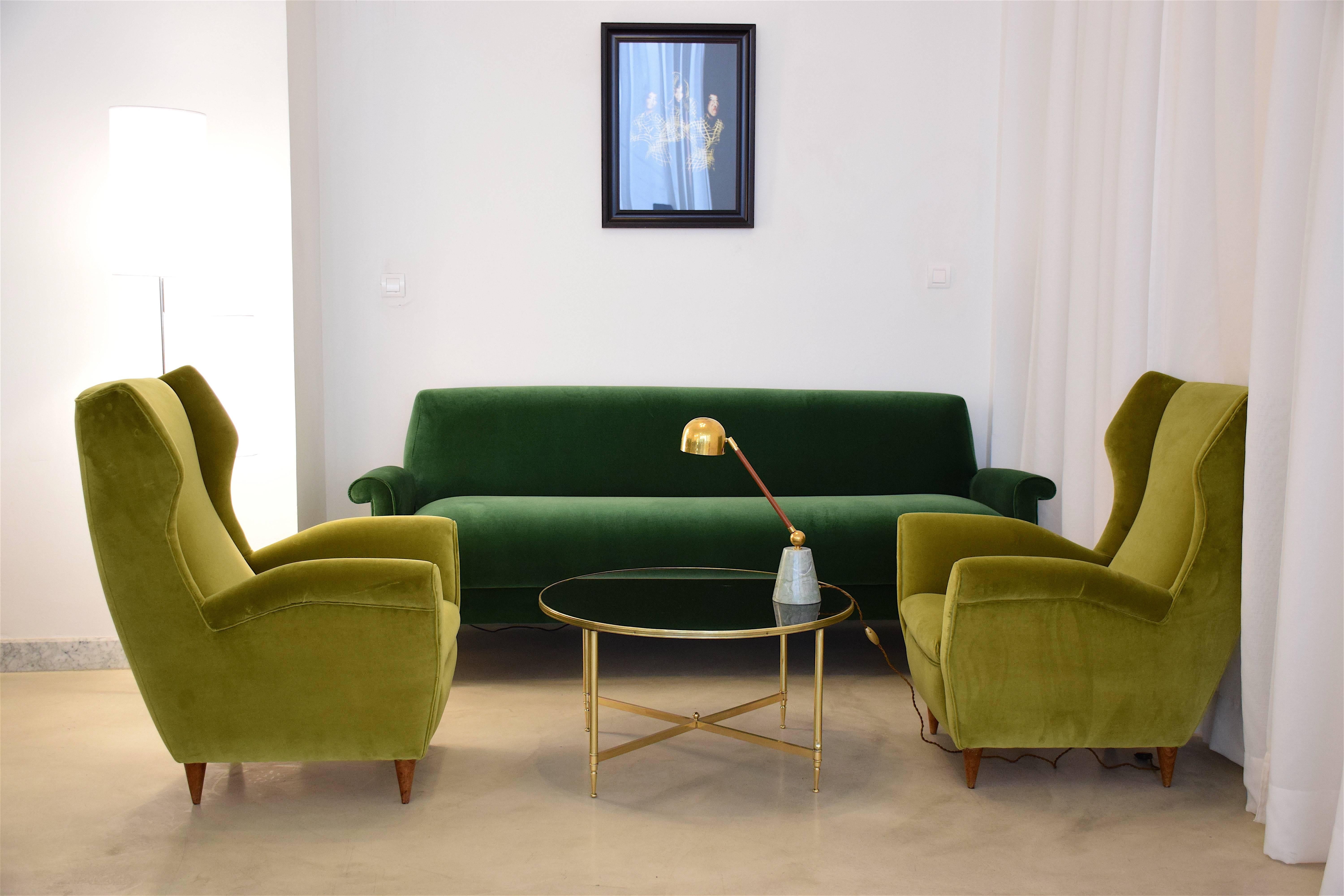 Vibrant sofa from Italy circa 1950-1960s has been meticulously restored with Lelièvre Paris forest green velvet upholstery, one of the highest quality fabric makers in France and new foam padding. The splayed steel legs have deliberately been left