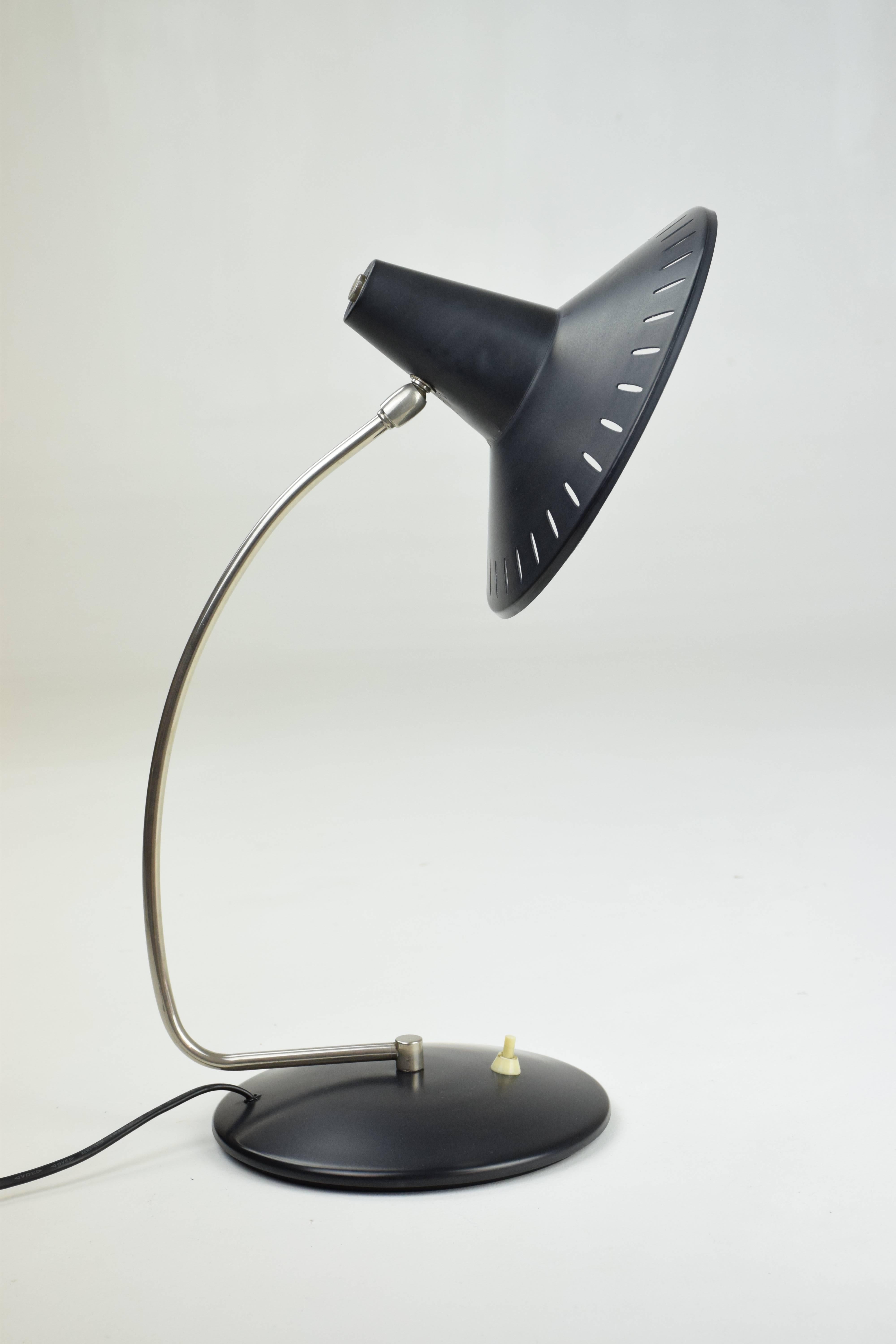 20th century vintage mid-century modern style desk lamp composed of a black lacquered steel structure, chrome arm and a perforated shade. With light switch at the base. 

Italy, circa 1950s.