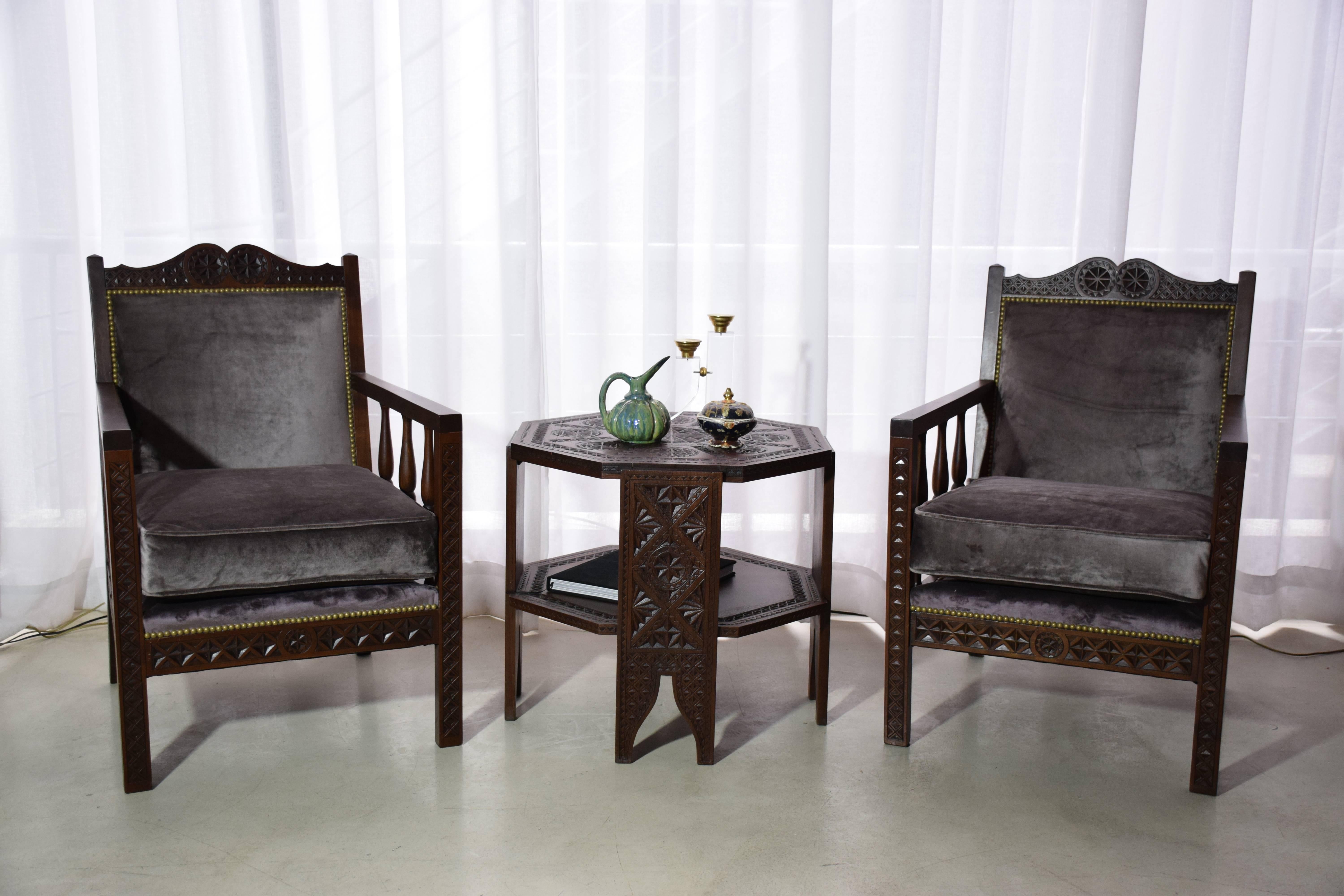 A 20th century vintage set of four Moorish armchairs and corresponding coffee table by Jules Grosso's French manufacturing company, circa 1930s. The pieces are composed of intricately hand-carved mahogany and beechwood. Fully restored through new
