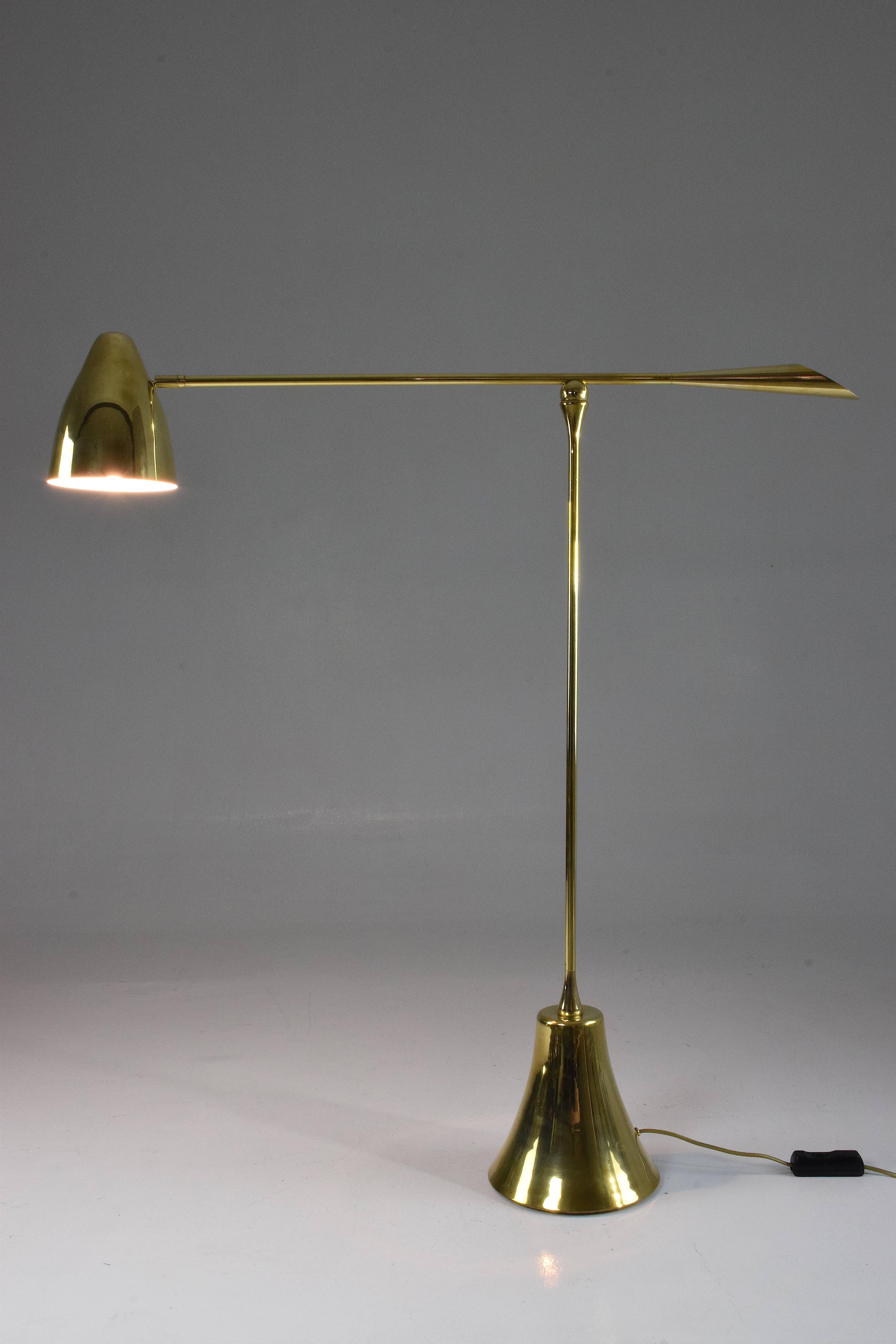 Equilibrium
Definition: when opposite forces are in total harmony 

Contemporary handcrafted floor lamp composed of a thick solid polished brass structure which articulates at the base and mid-arm with a hand-engraved pattern on the handle. The