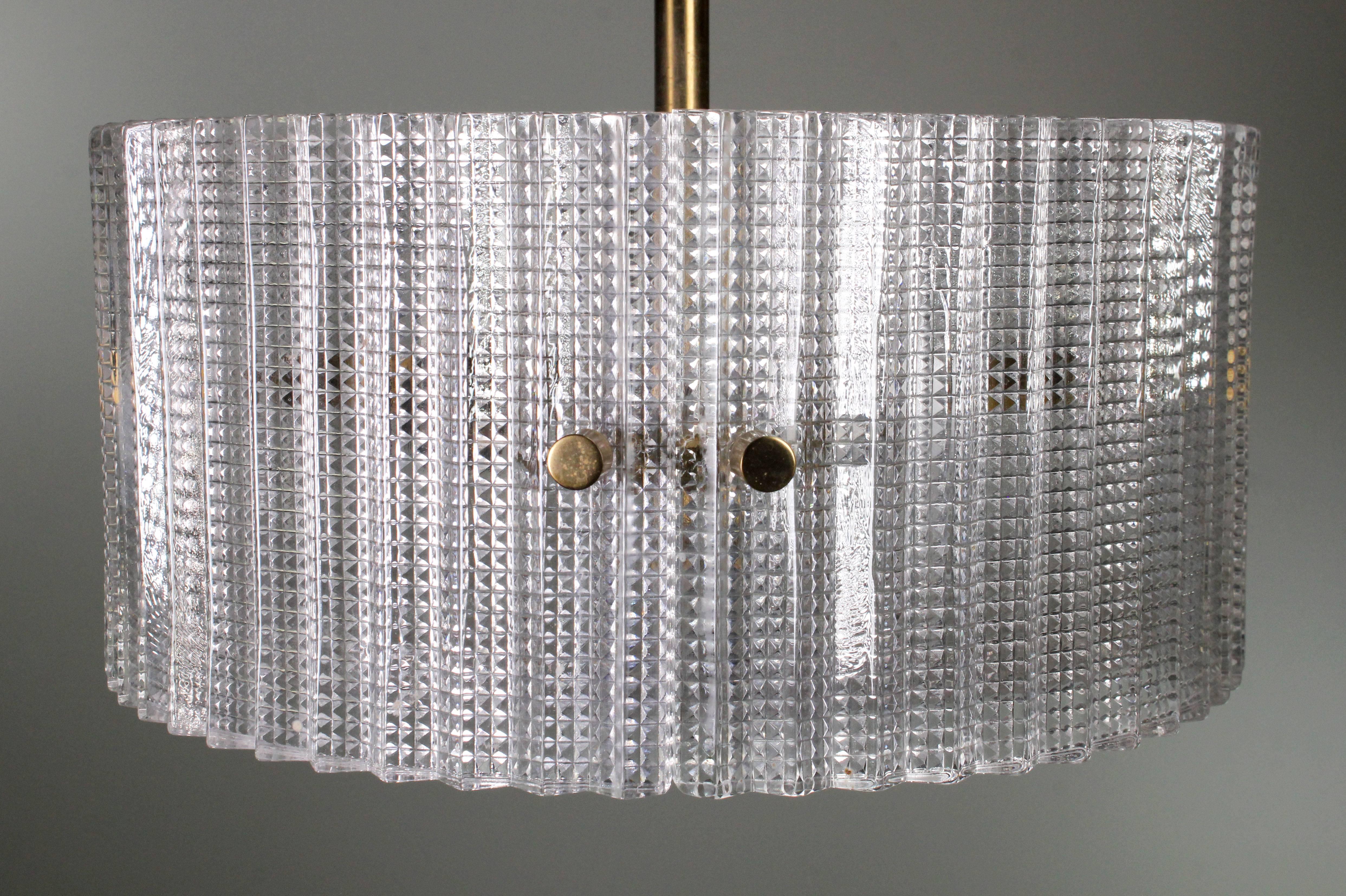Stunning Swedish Mid-Century Modern textured glass pendant with brass mount and details. Three rounded glass panels held together in a circle with a textured glass base. By acclaimed Swedish designer Carl Fagerlund and manufactured at Orrefors