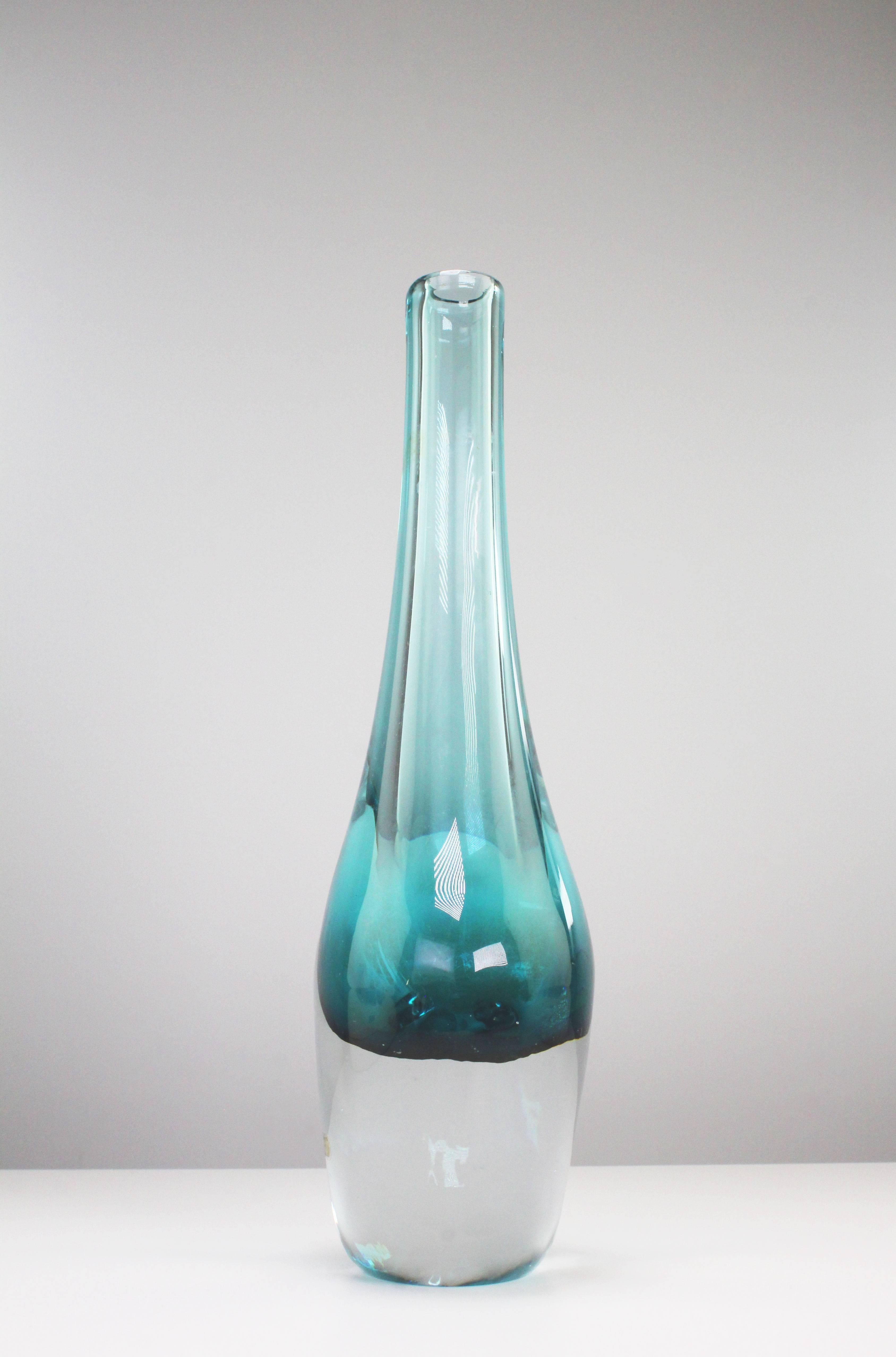 Scandinavian Mid Century Modern soft shaped handblown asymmetrical solid glass vase with aqua green top and clear glass bottom. Manufactured by Smålandshyttan in Sweden in the 1960s. Original small golden label on front with name of manufacturer and