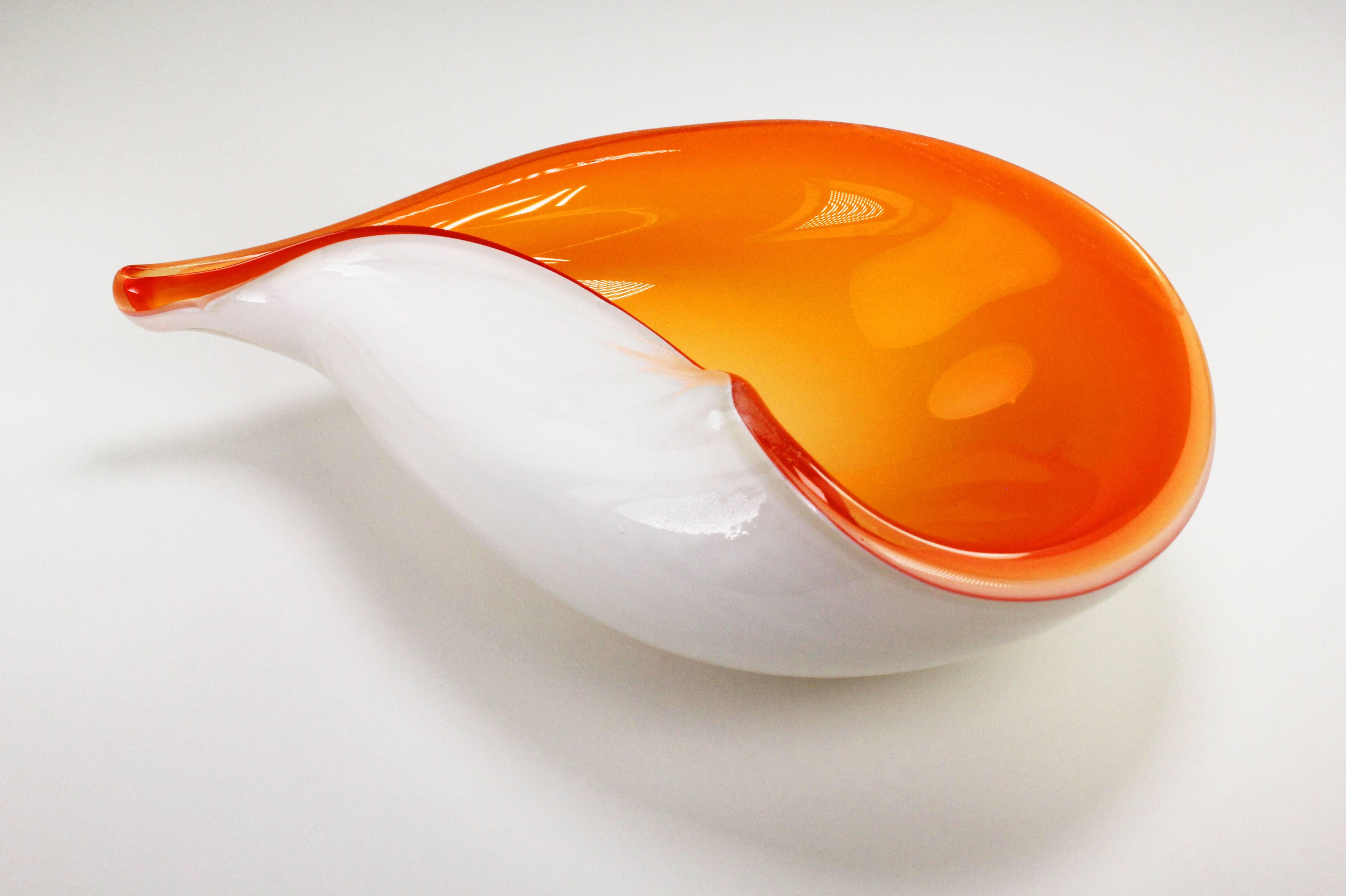 Italian Mid Century Modern smooth sea shell shaped Murano bowl in bright orange glass encased in milky white handblown glass attributed to Alfredo Barbini in the 1950s. Absolutely beautiful condition. Free shipping.