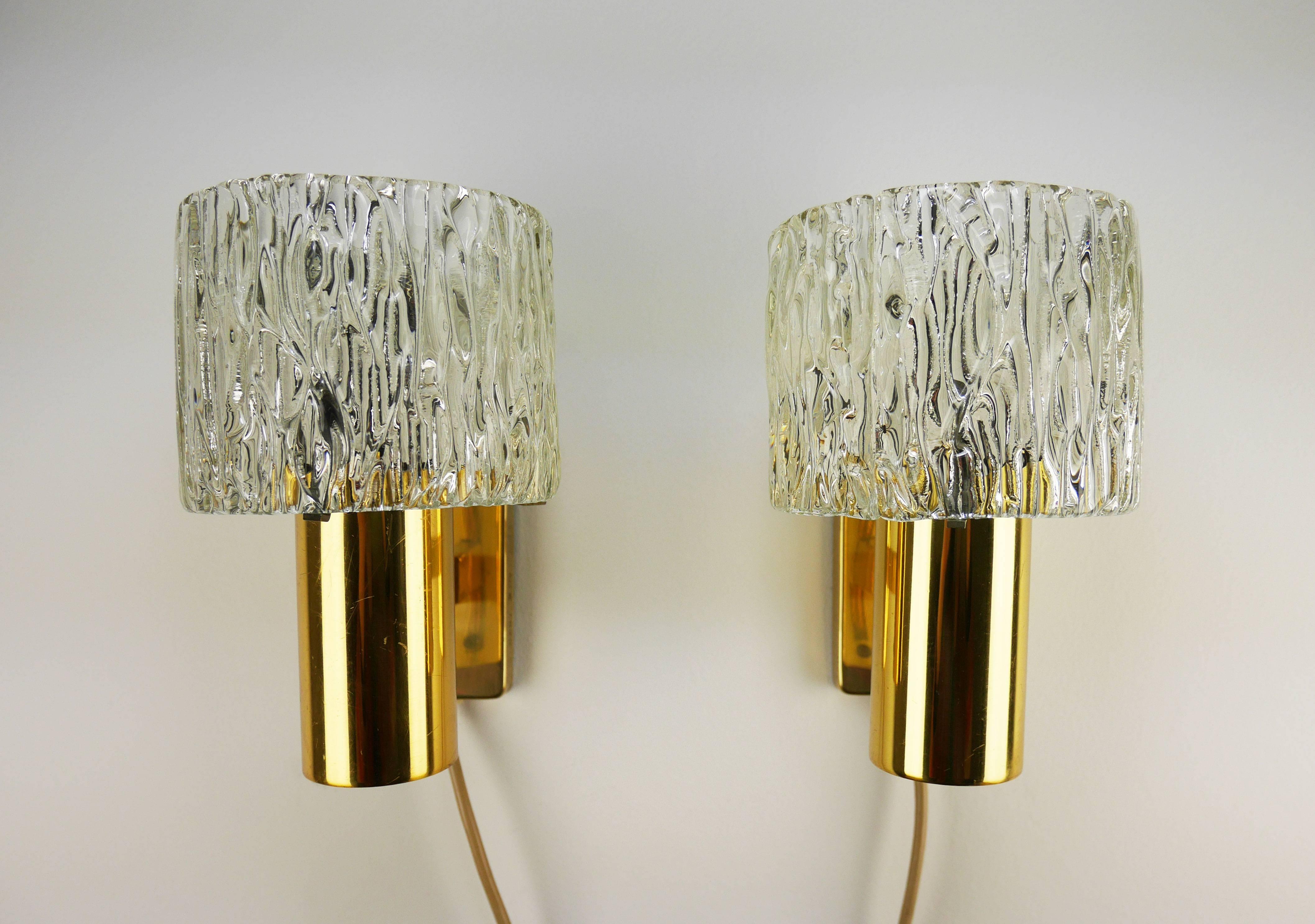 Three elegant pairs of Scandinavian Modern wall lights by Carl Fagerlund for Swedish Orrefors. Thick, textured tubular glass on brass mount. Manufactured in Sweden in the late 1950s. Model 8397. Some items are marked on one side. Items are in